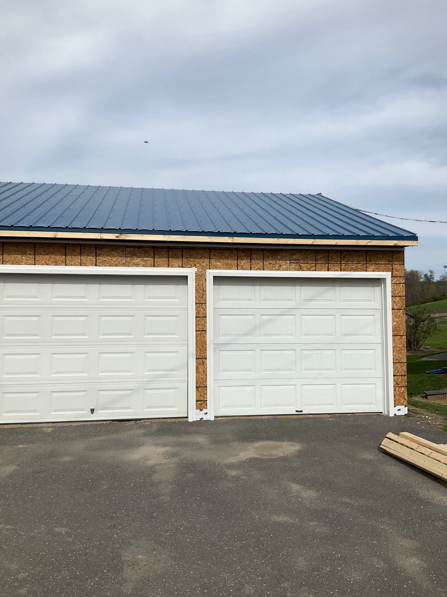 3-Car Garage refresh Blue Metal Roofing in Herndon by Esh Builders