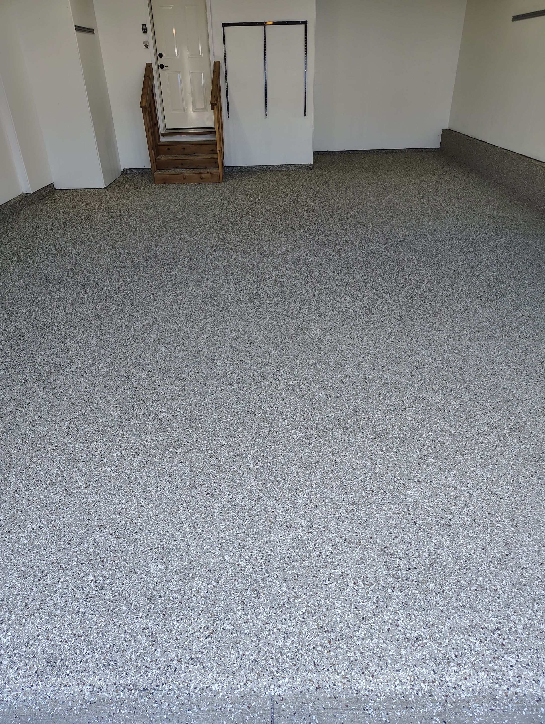 Sioux Falls Garage Floor Transformation With Gray Speckled Epoxy Coating by Select Painting, Coatings & Garage Cabinets