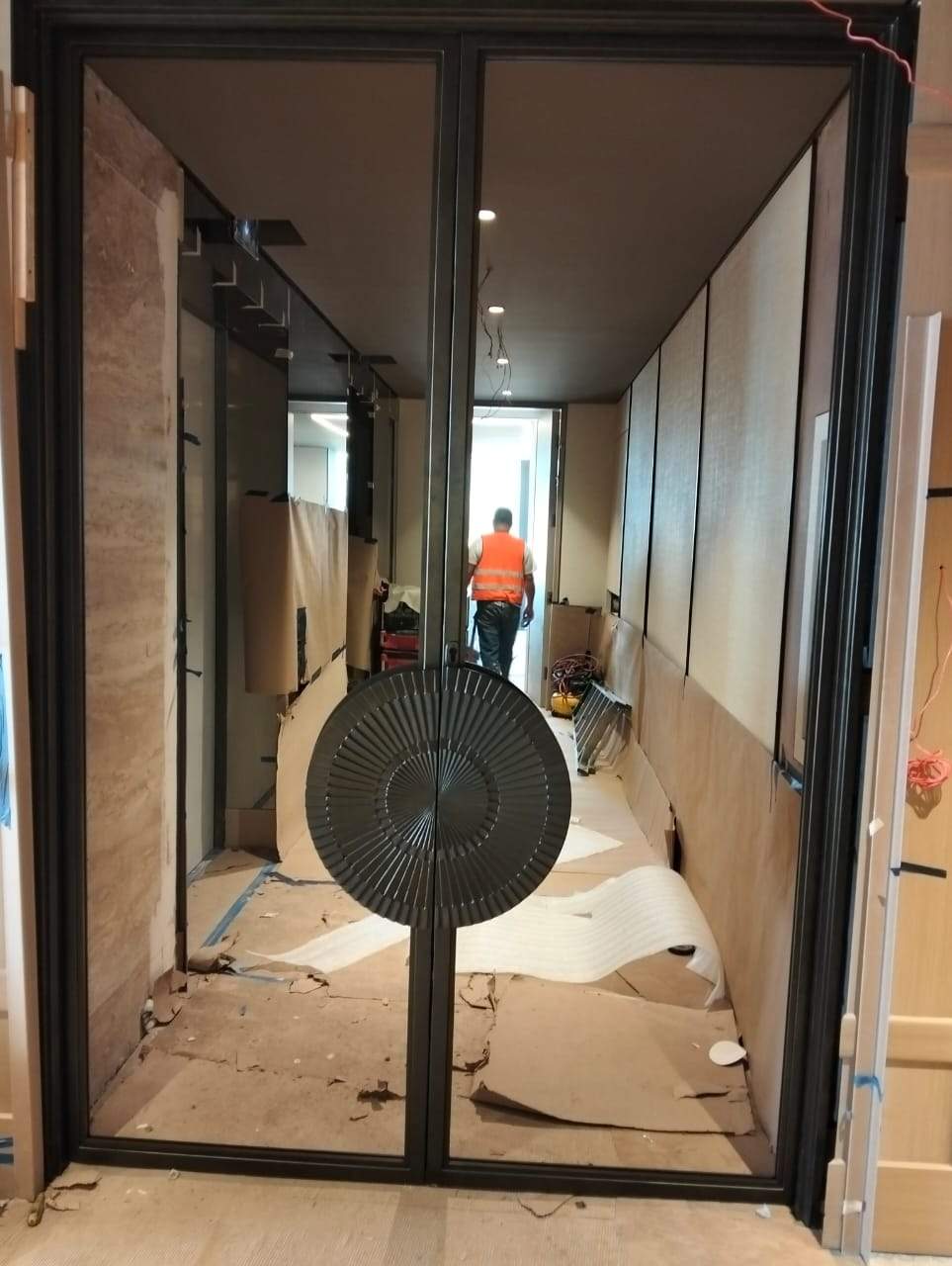 Modern Black Frame Double Door Installation with Custom Radial Hardware by Solara Custom Living