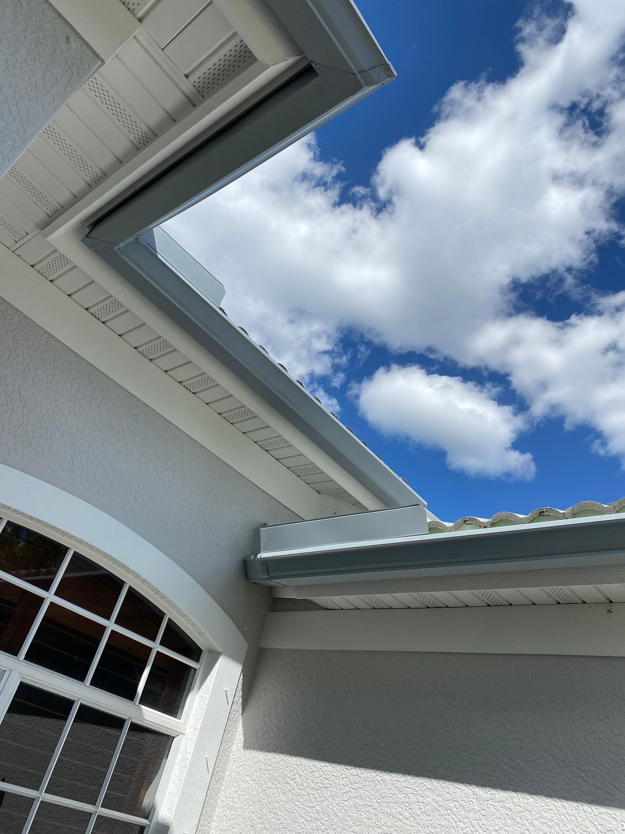 6-inch K-style Seamless Gutters and Splash Guard in Grey Color in Naples FL by Gutter Professors