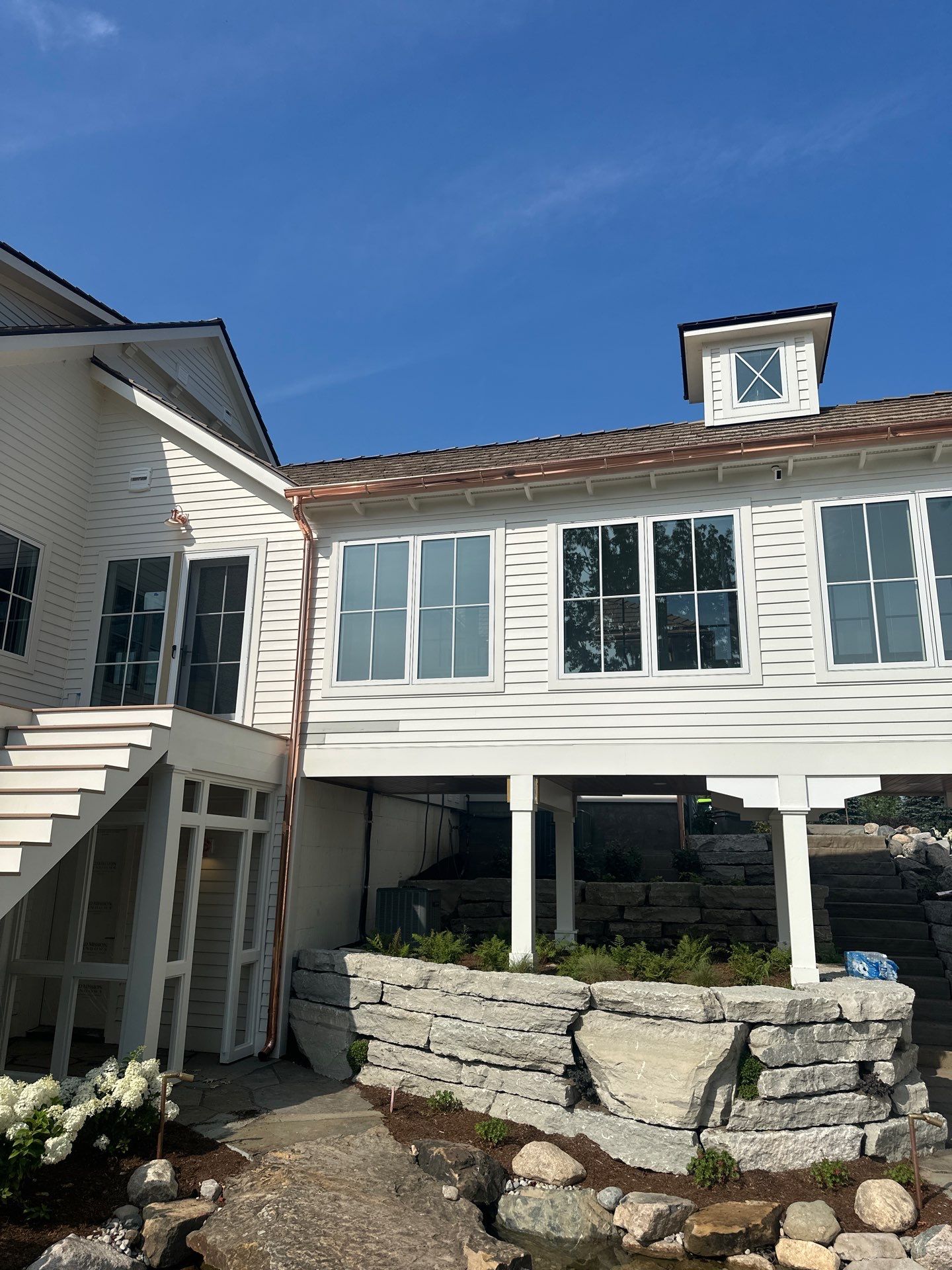 Custom Copper Gutter System and Accent Roofing in East Jordan by Rainbow Seamless Systems