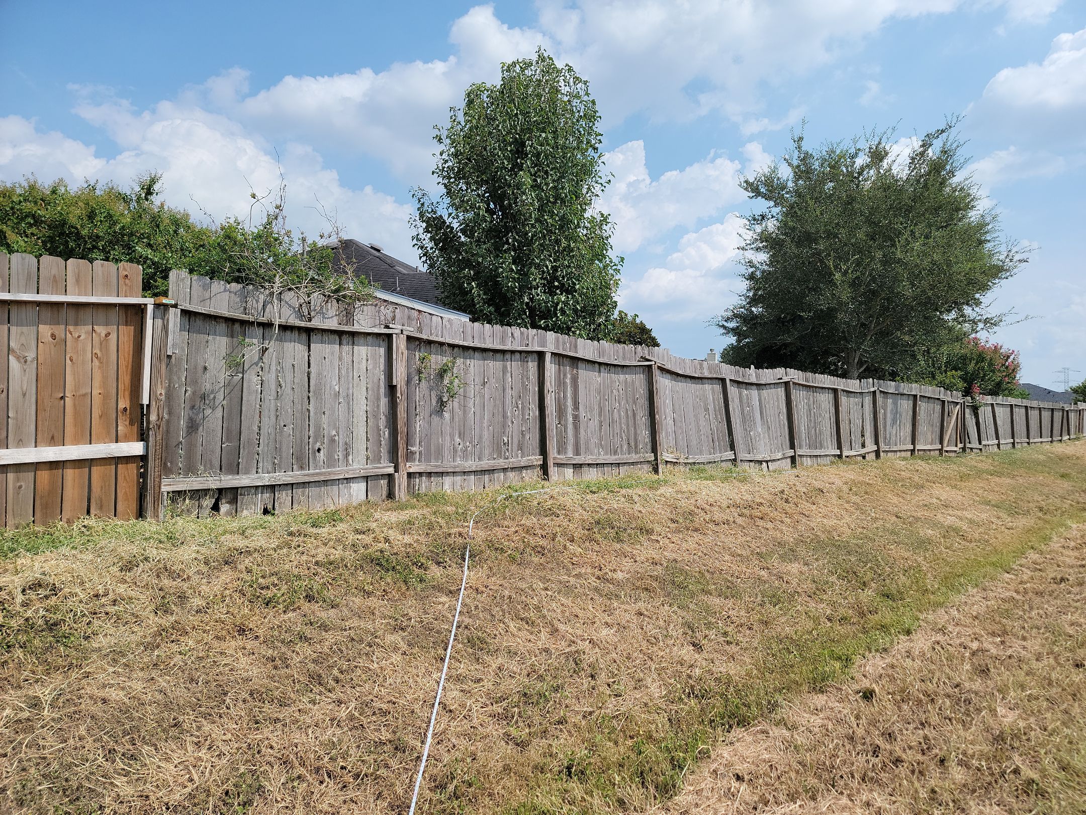 Beautiful Wood fence with metal posts by Tim's Fences