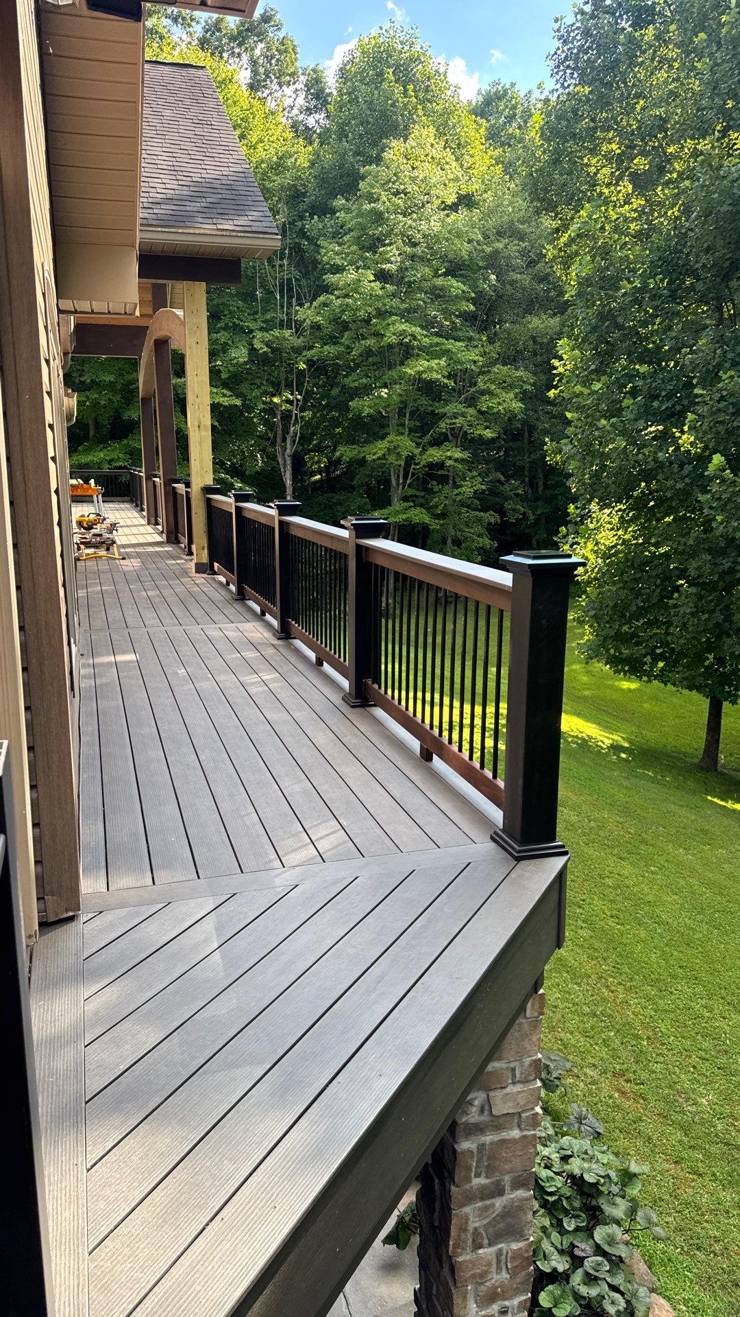 Custom Composite Deck Construction with Stone Pillars in Fayetteville by Walnut Hollow Decks & Outdoor Living