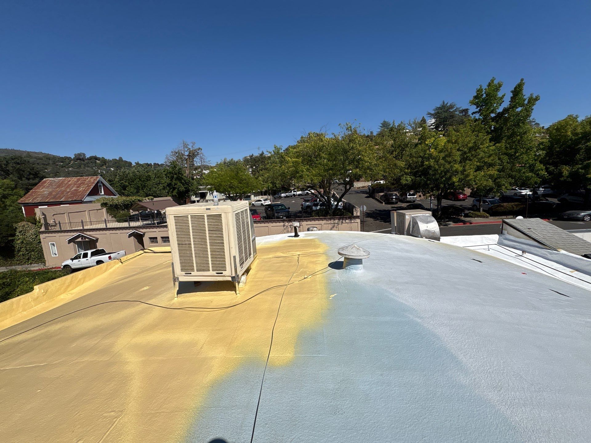 Foam and coatings on commercial roof by Straight Edge Roofing Inc