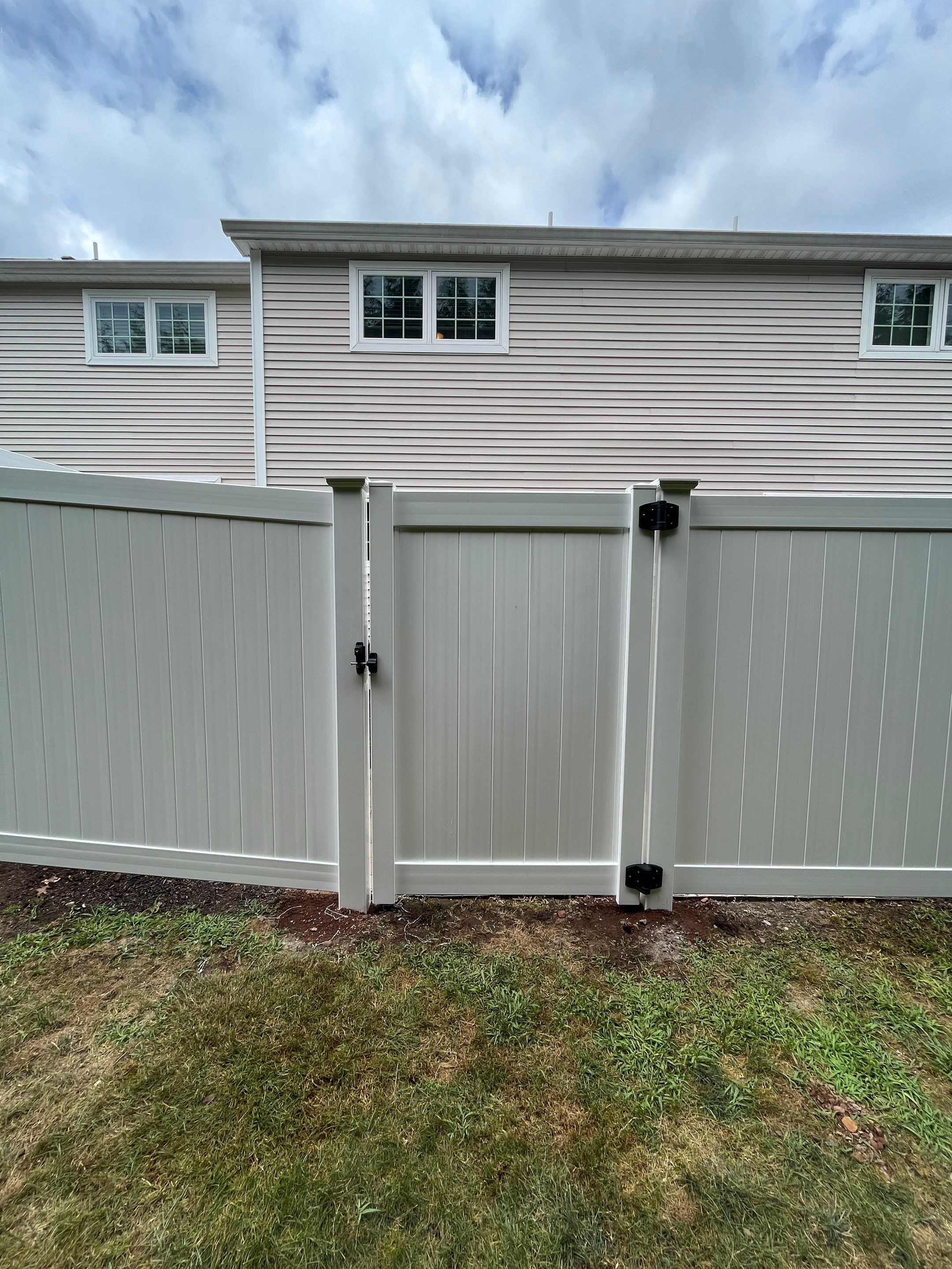 Vinyl privacy fence and matching gate  by DiGiorgi Roofing and Siding Inc