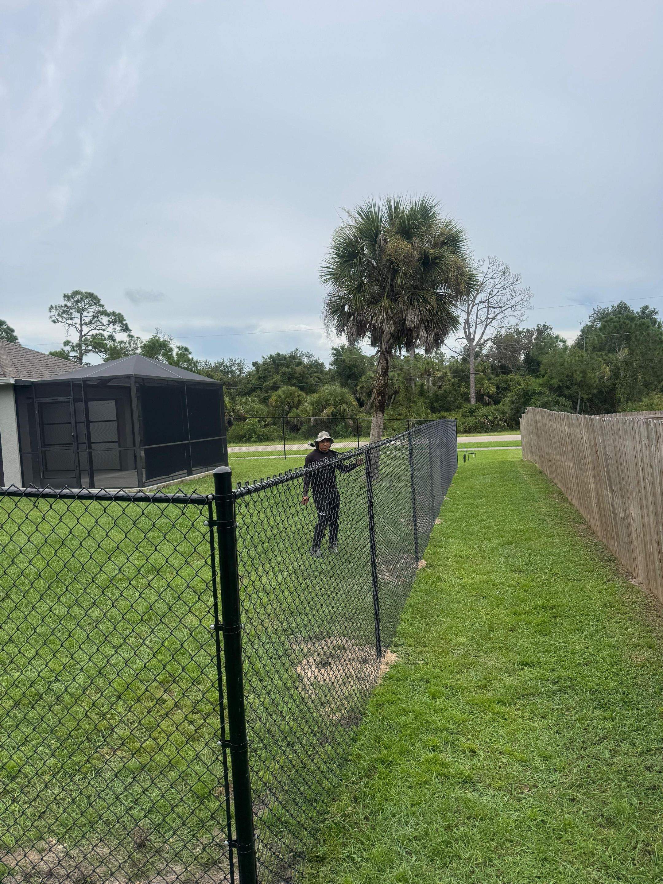 Black Chain Link Boundary Fence with Access Gates in North Port by True Fence LLC