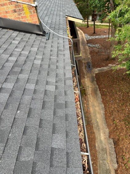 Commercial gutter cleaning Charlotte, NC before photo with filled gutters