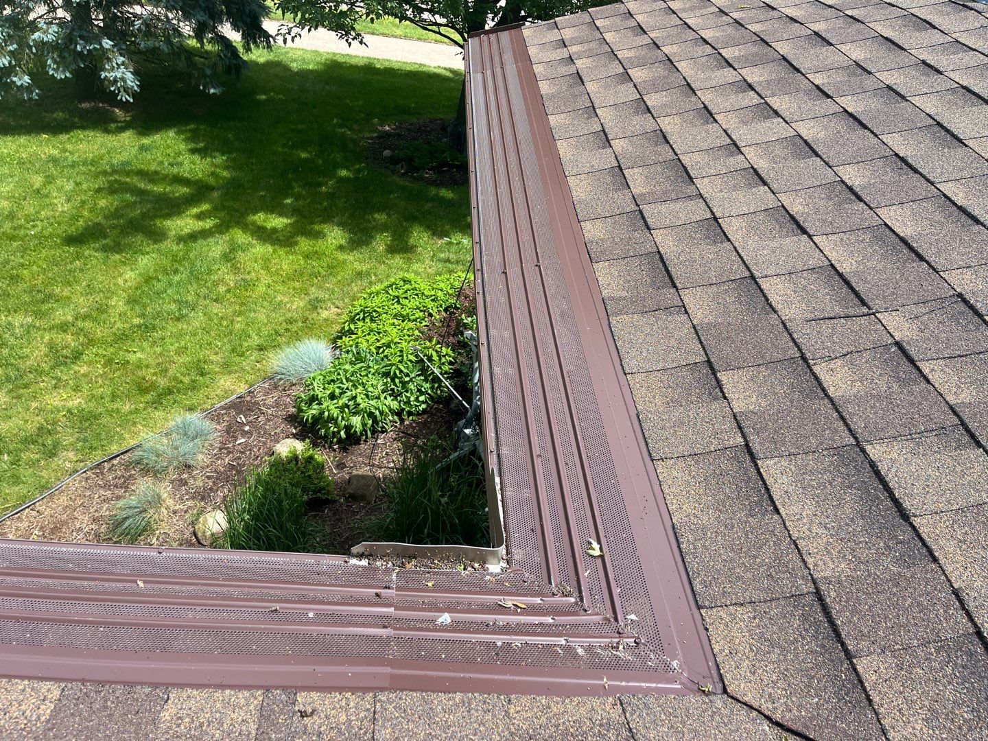 Installing new Roof and Gutter Protection after Hail Damage by Acme Exteriors