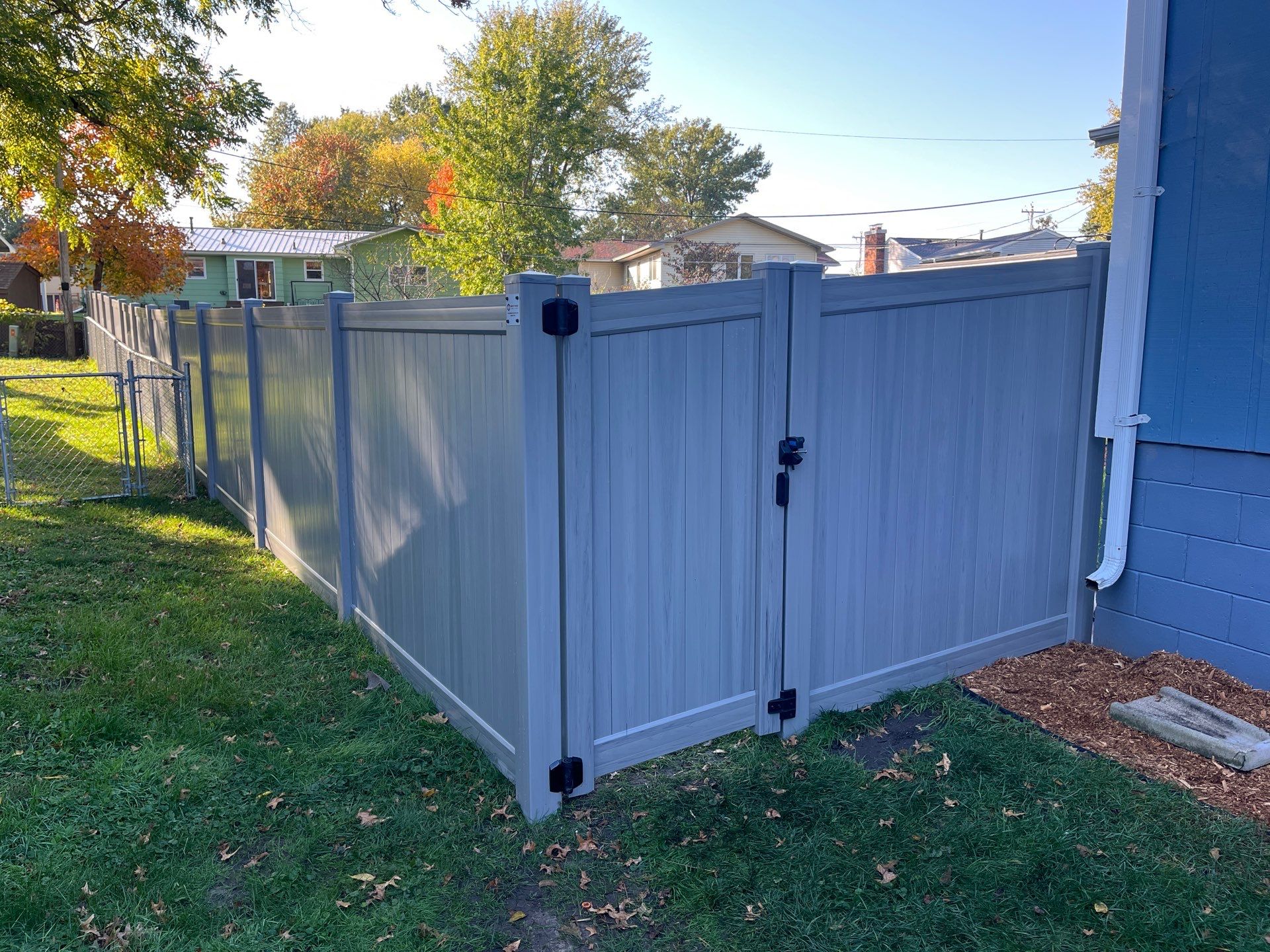 Chai Gray Vinyl Privacy Fence and Gate Installation in Cedar Falls by Perfect Picket Fence and Stain