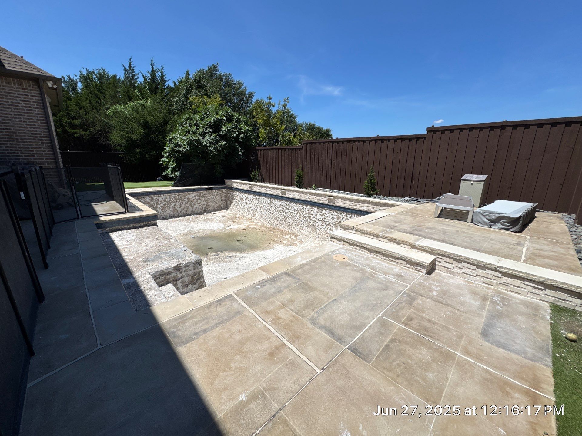 Geometric Pool with Raised Stone Waterfall Wall by Pinnacle Pools and Spas - DFW