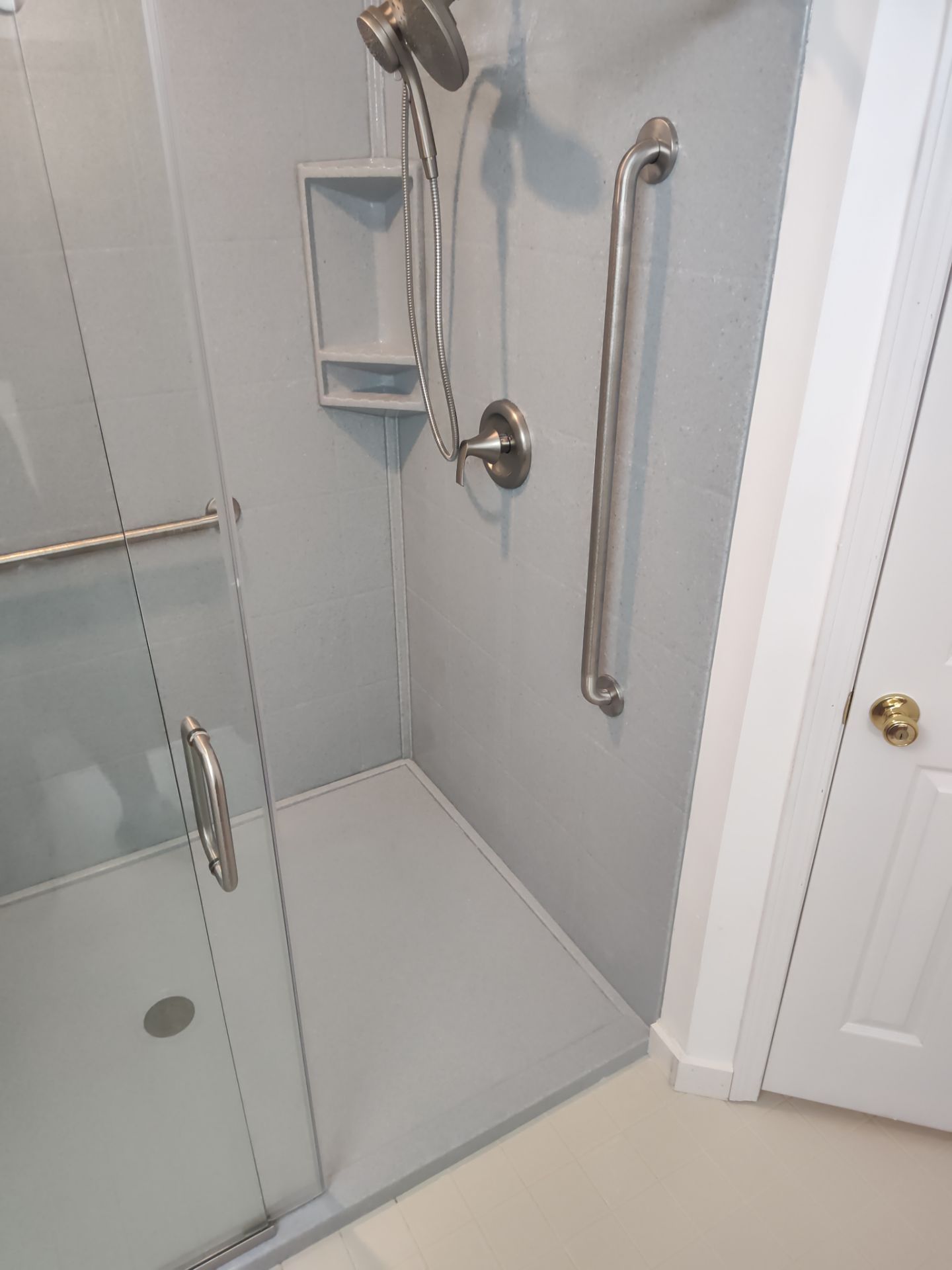 Bathroom Remodel using Onyx base and shower walls with seat & caddie by Cornerstone Home Builders, LLC