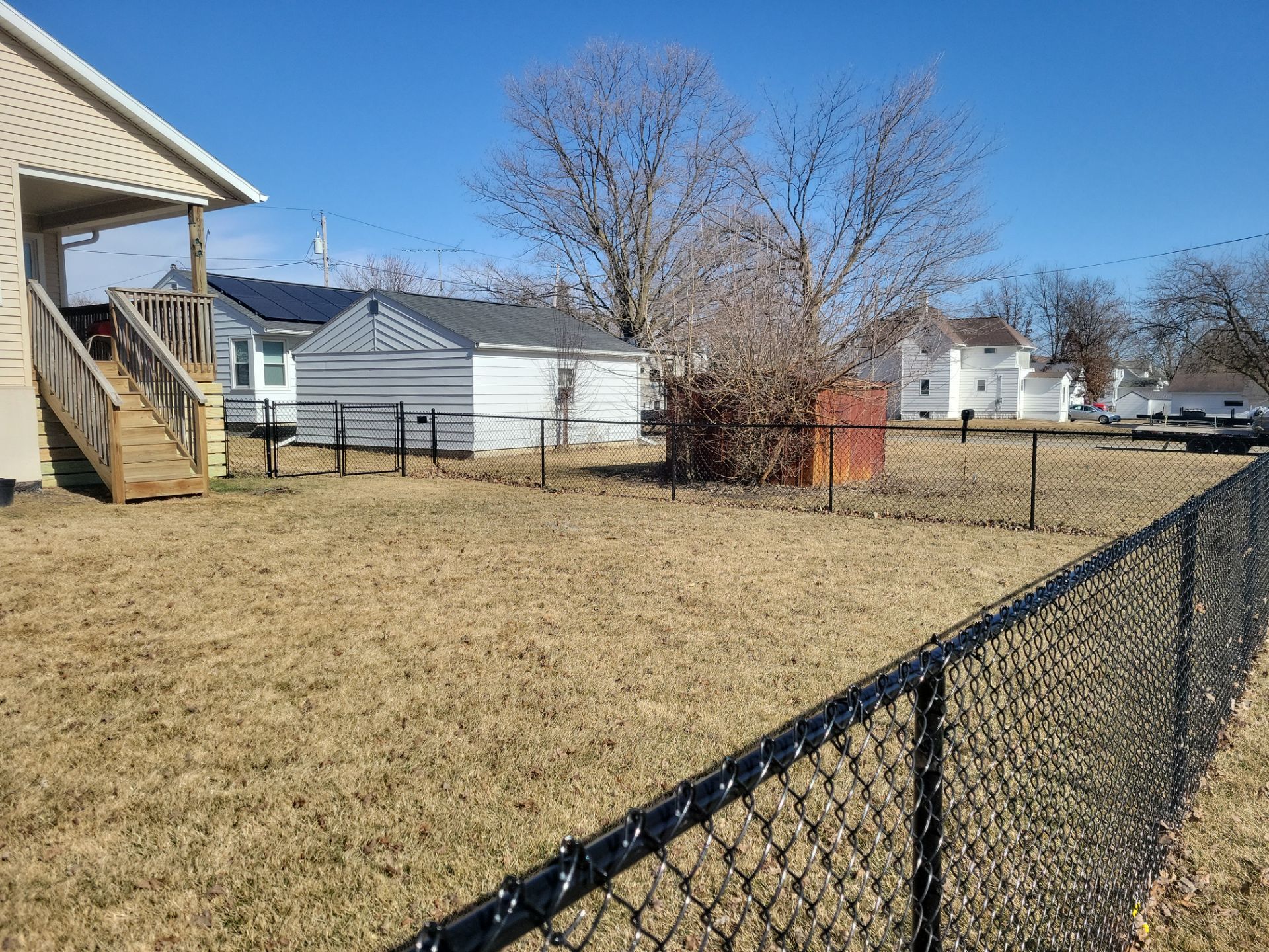 Residential Black Chain Link Fence and Gate Installation in Tripoli by Perfect Picket Fence and Stain