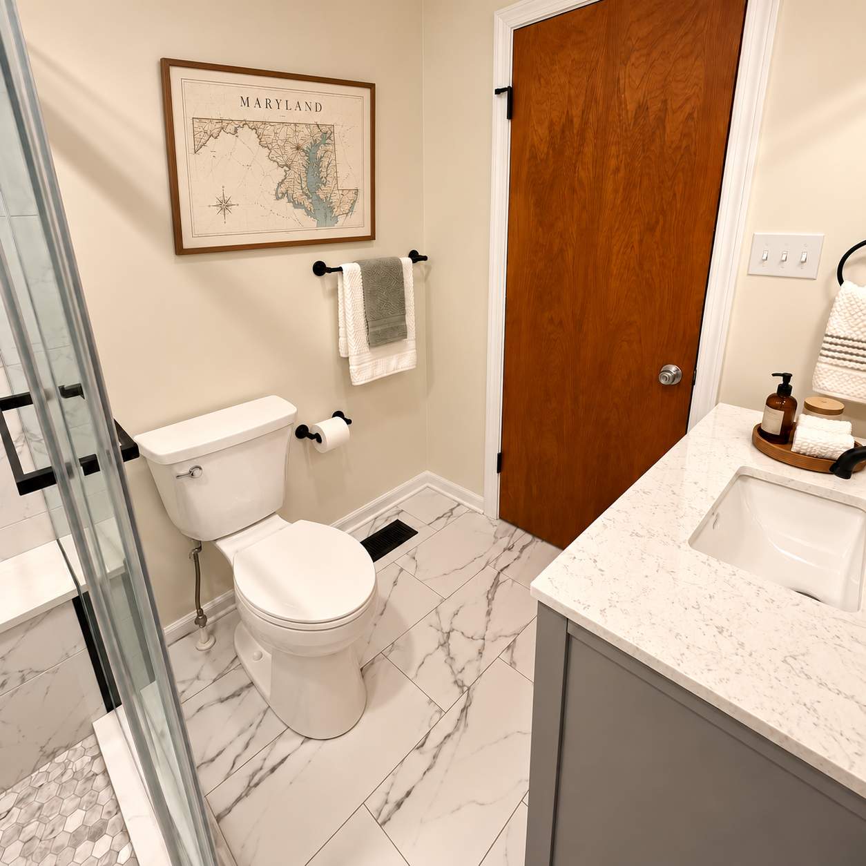 Modern Bathroom Remodel with Marble Tile & Matte Black Finishes by Remodel Now