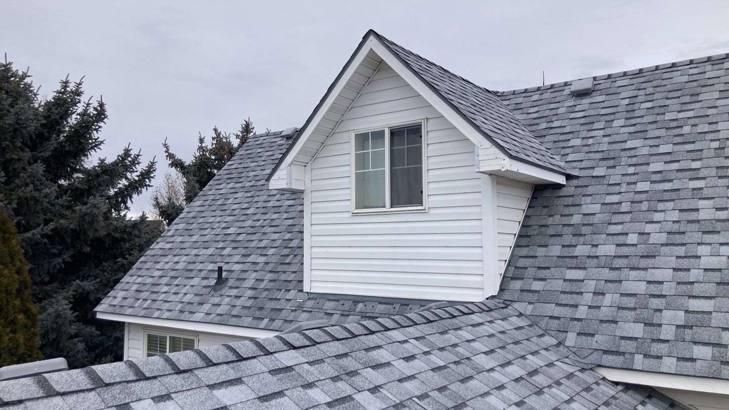 Two story farmhouse style roofing installation using Owens Corning Duration in the color Teak by ID Roofing LLC