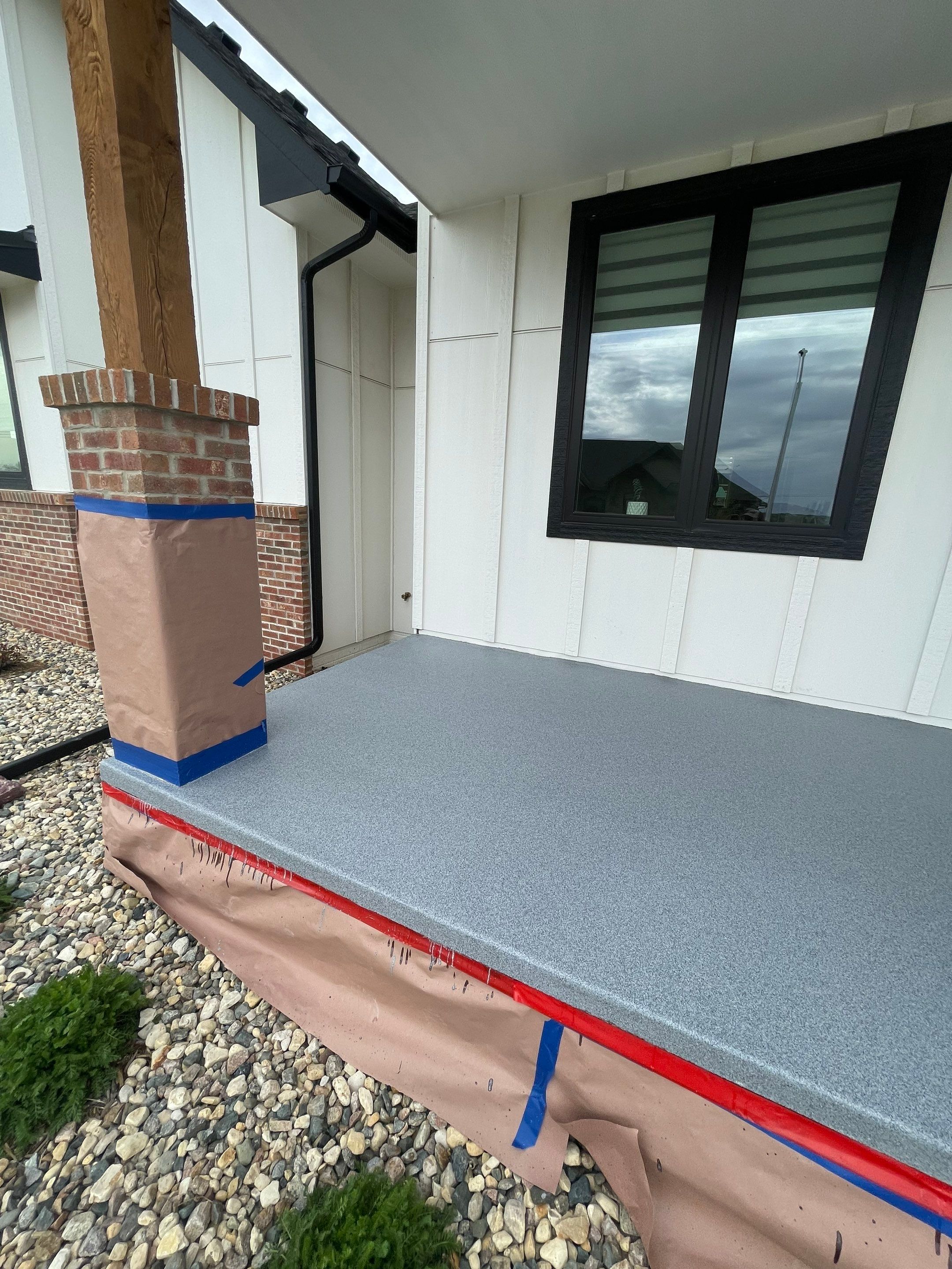 Grey Speckled Concrete Porch Coating for Sioux Falls Home by Select Painting, Coatings & Garage Cabinets