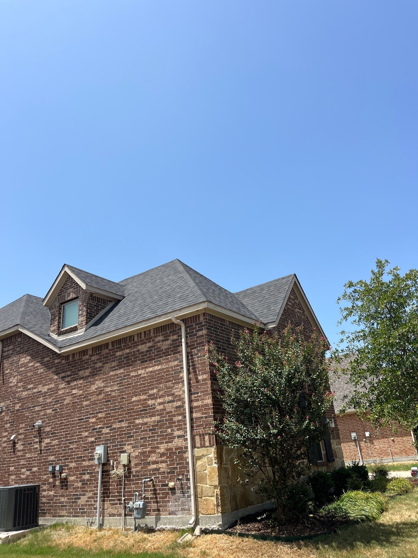 IKO Glacier-Brown Brick house by Tejas Roofworks + Restoration