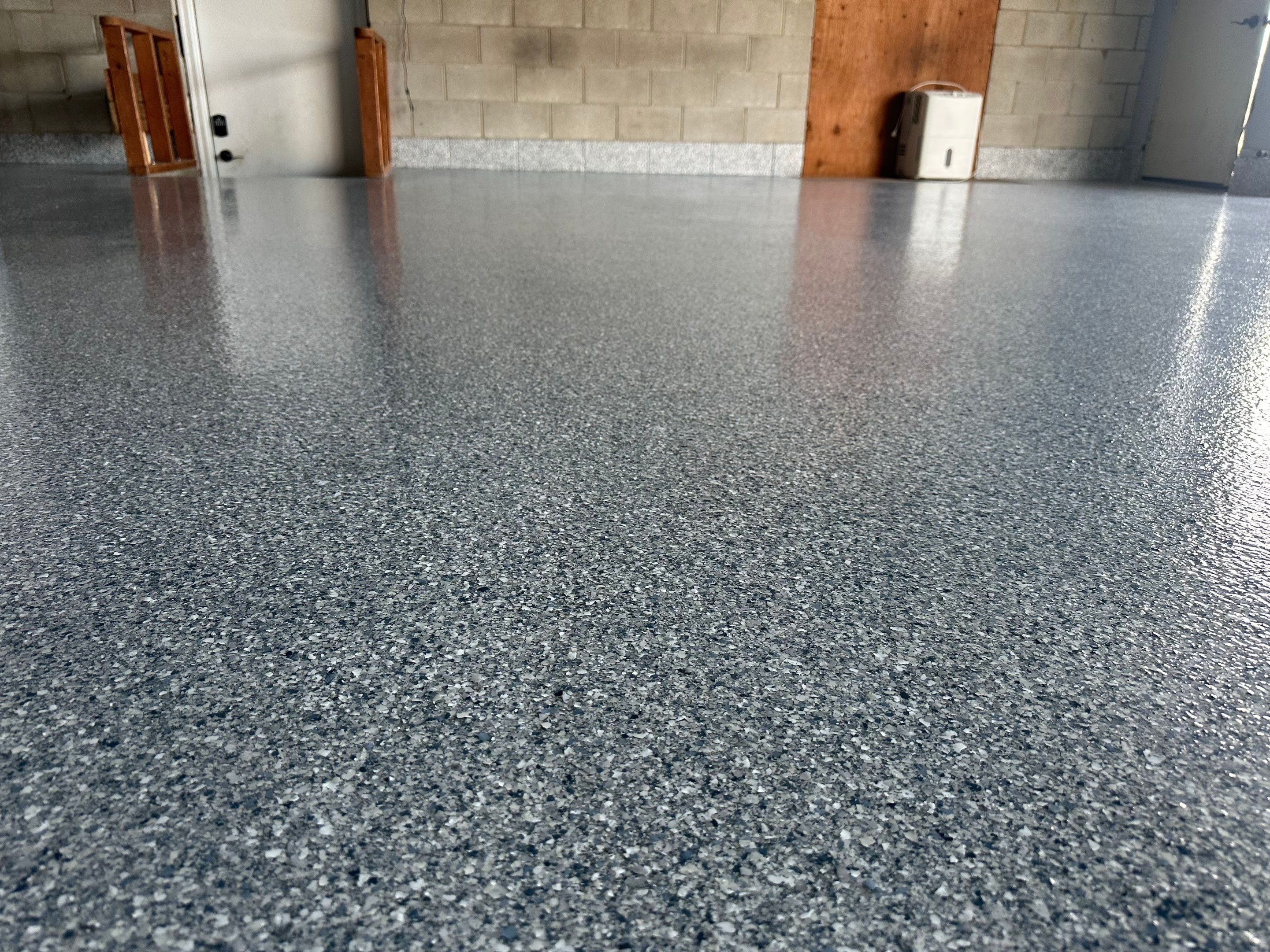 Multi-Colored Speckled Concrete Floor Coating Installation in Sioux Falls by Select Painting, Coatings & Garage Cabinets