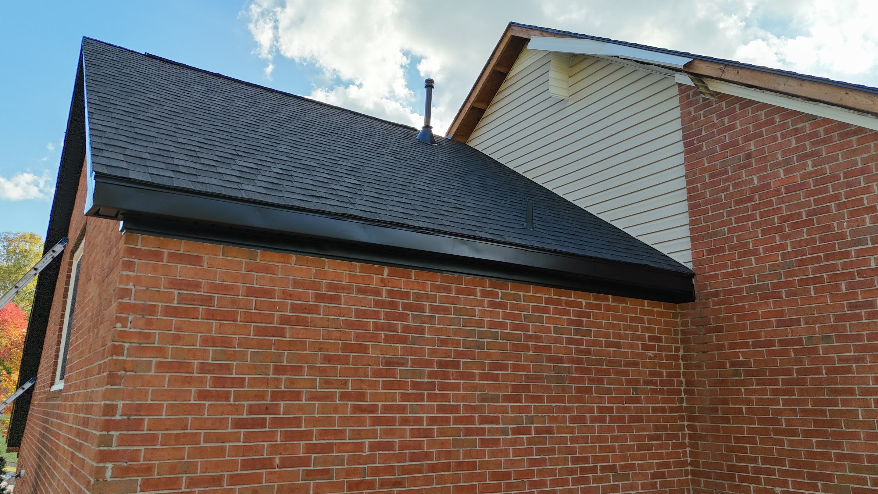 Charcoal Black Re-Roof & Gutters by Royal House LLC