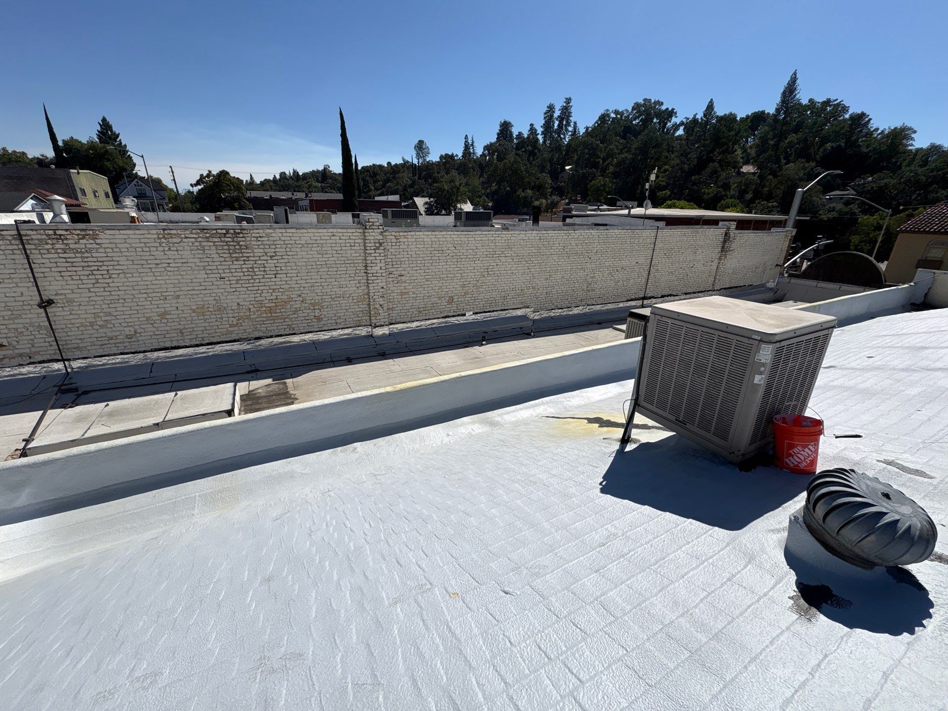 Foam and coatings on commercial roof by Straight Edge Roofing Inc