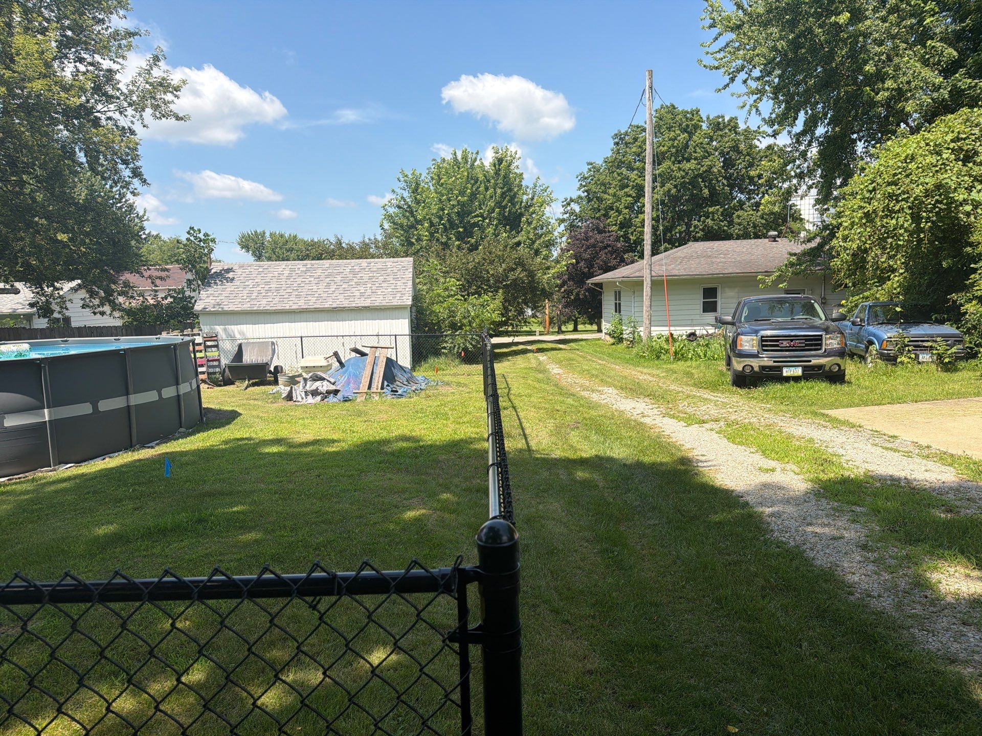 Black Chain Link Backyard Fence Installation in Tripoli, IA by Perfect Picket Fence and Stain