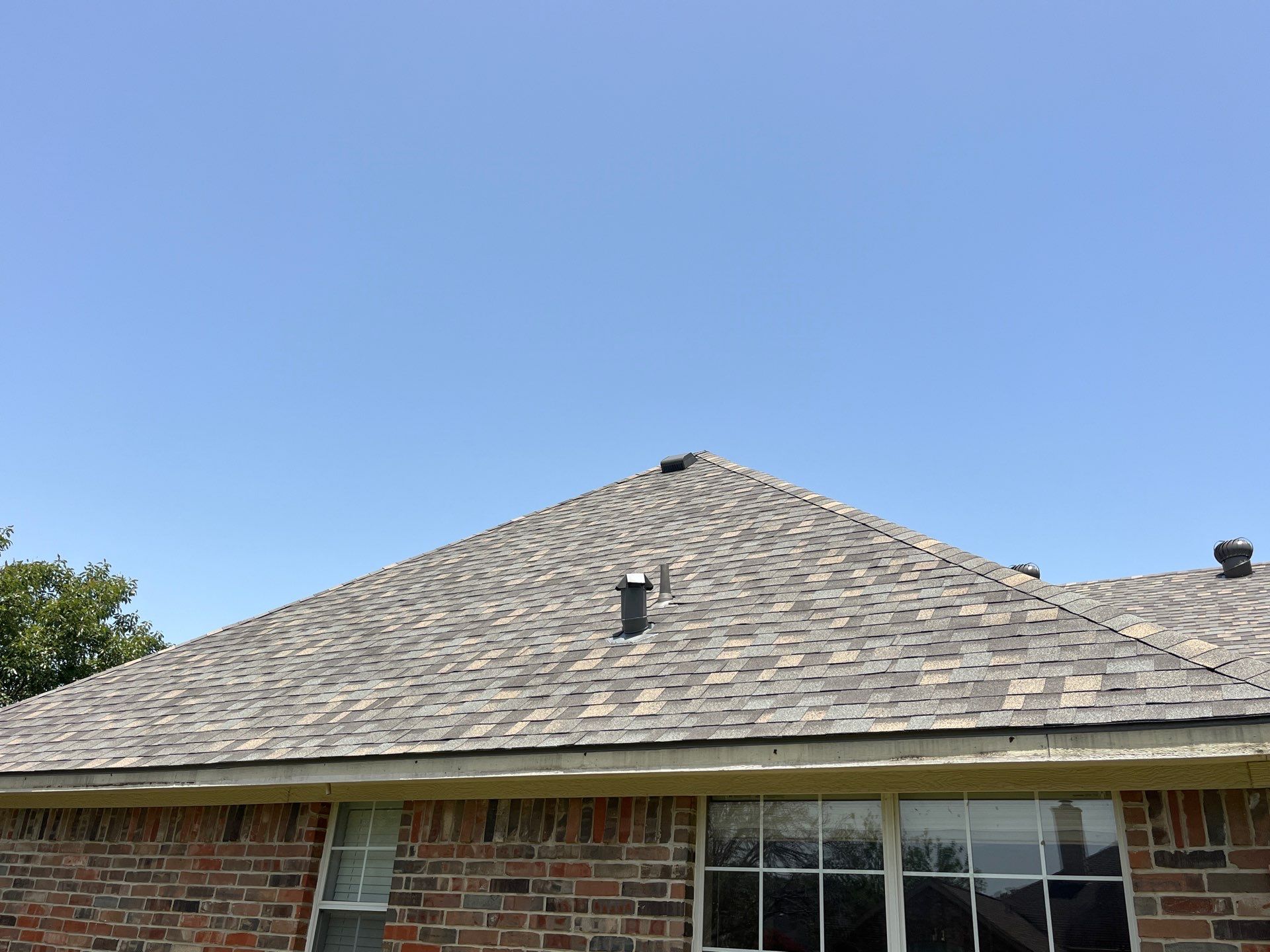 Red brick with IKO Cornerstone  by Tejas Roofworks + Restoration