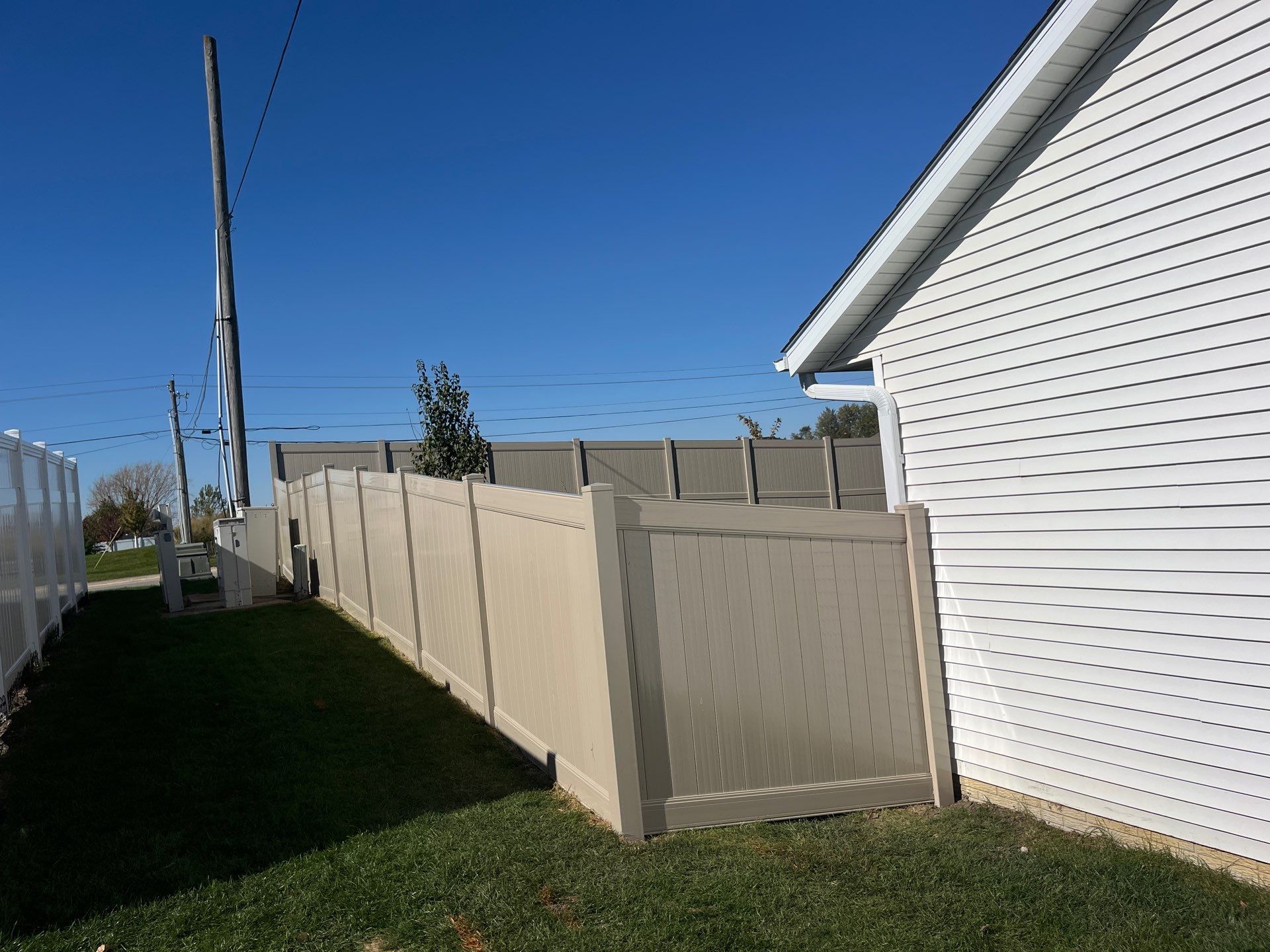 Adobe Vinyl Privacy Fence and Gate Installation in Cedar Falls by Perfect Picket Fence and Stain