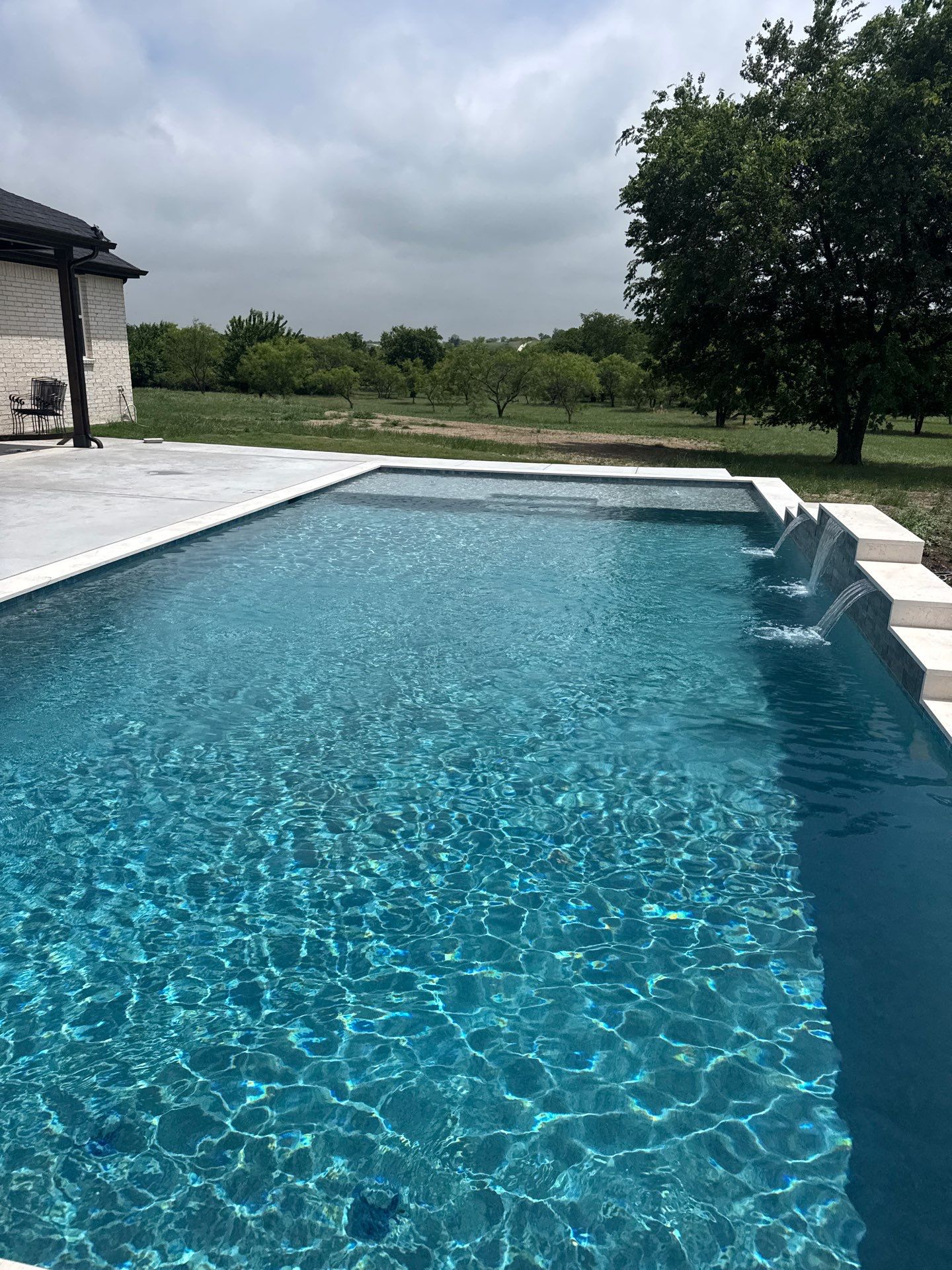 Expansive Geometric Pool with Countryside Views by Pinnacle Pools and Spas - DFW