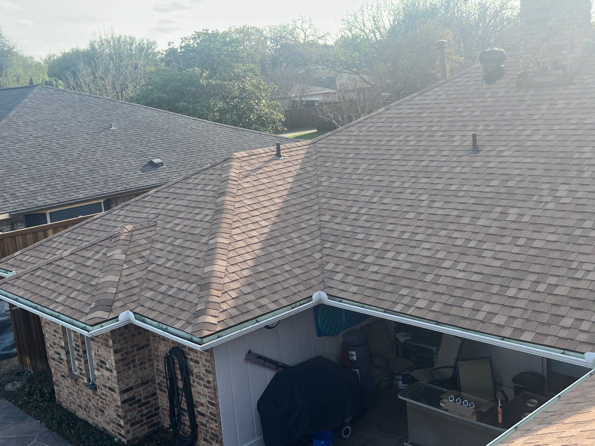 Medium brown brick with Tamko Rustic Cedar by Tejas Roofworks + Restoration