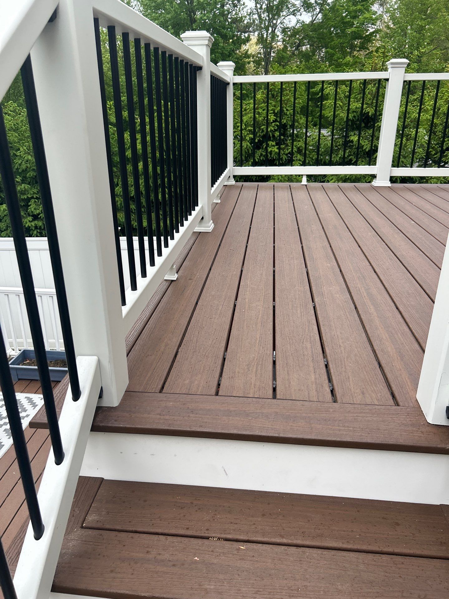 Elevated Composite Deck Replacement with White Railing in Tannersville by Herts Roofing & Construction