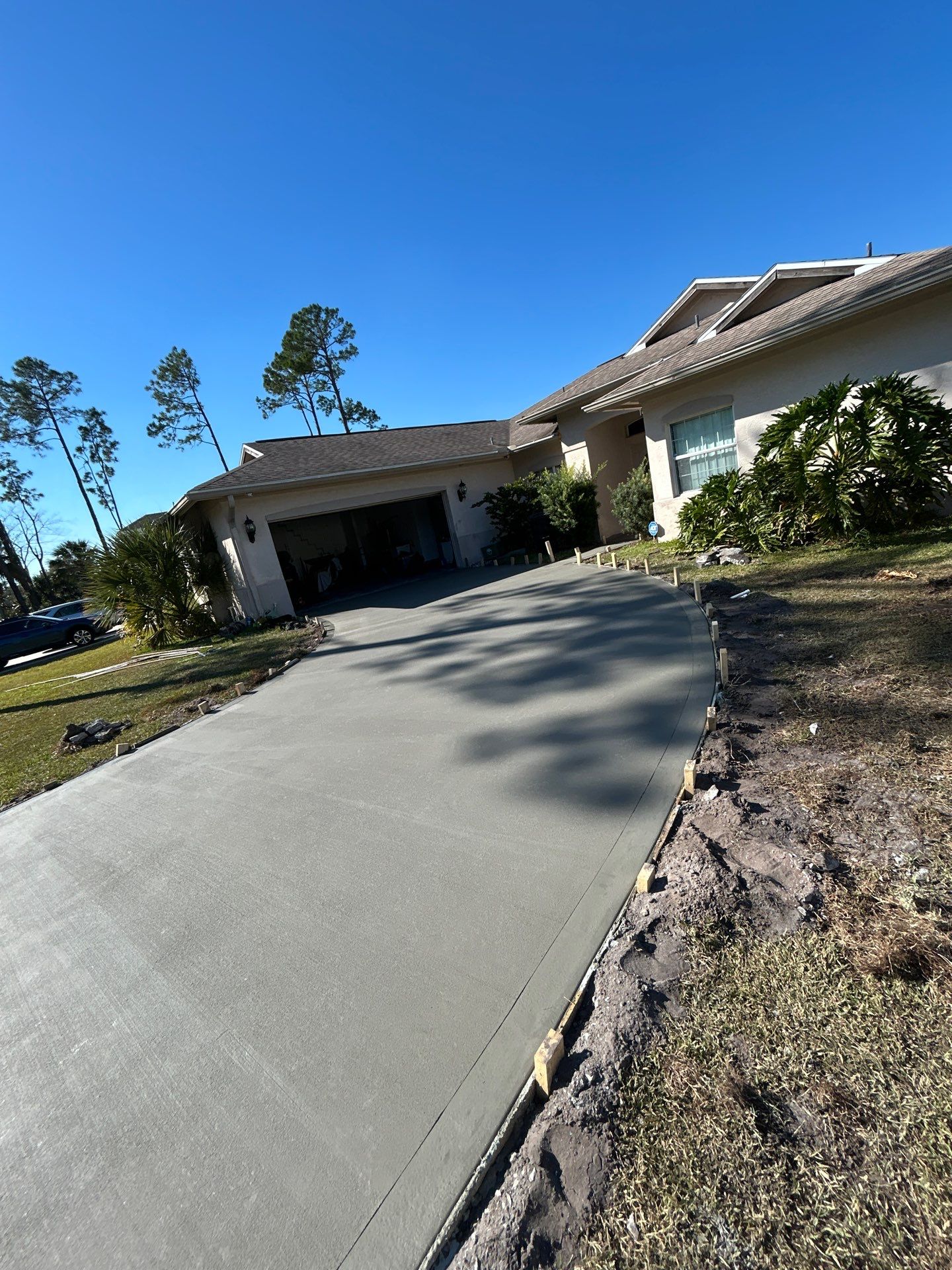 New concrete driveway by Courtesy screening