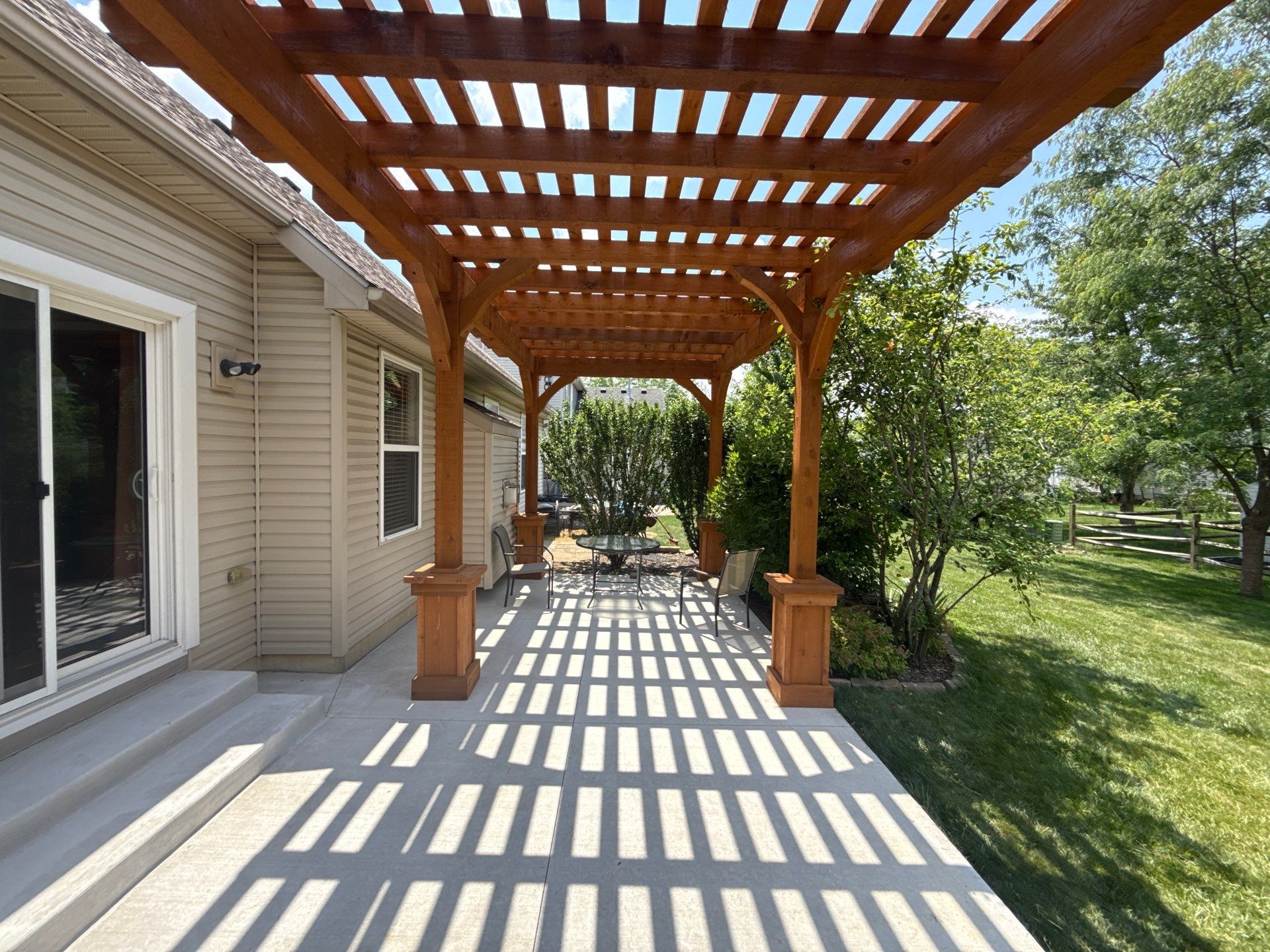 Custom Cedar Pergola and Concrete Patio Installation in Perrysburg by Farrell's Lawn & Garden Center LLC