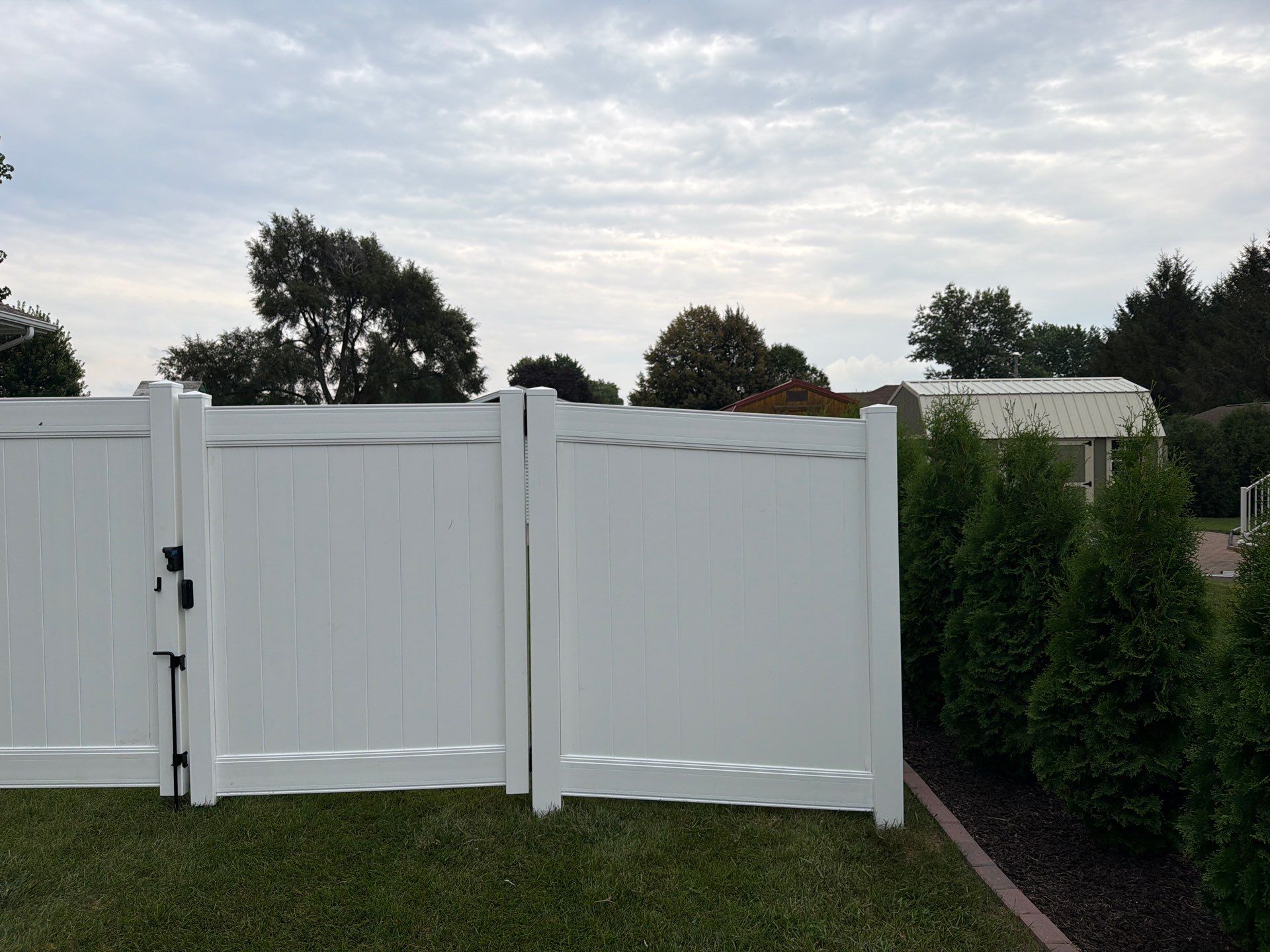 White Vinyl Privacy Fence and Double Gate Installation in Jesup by Perfect Picket Fence and Stain