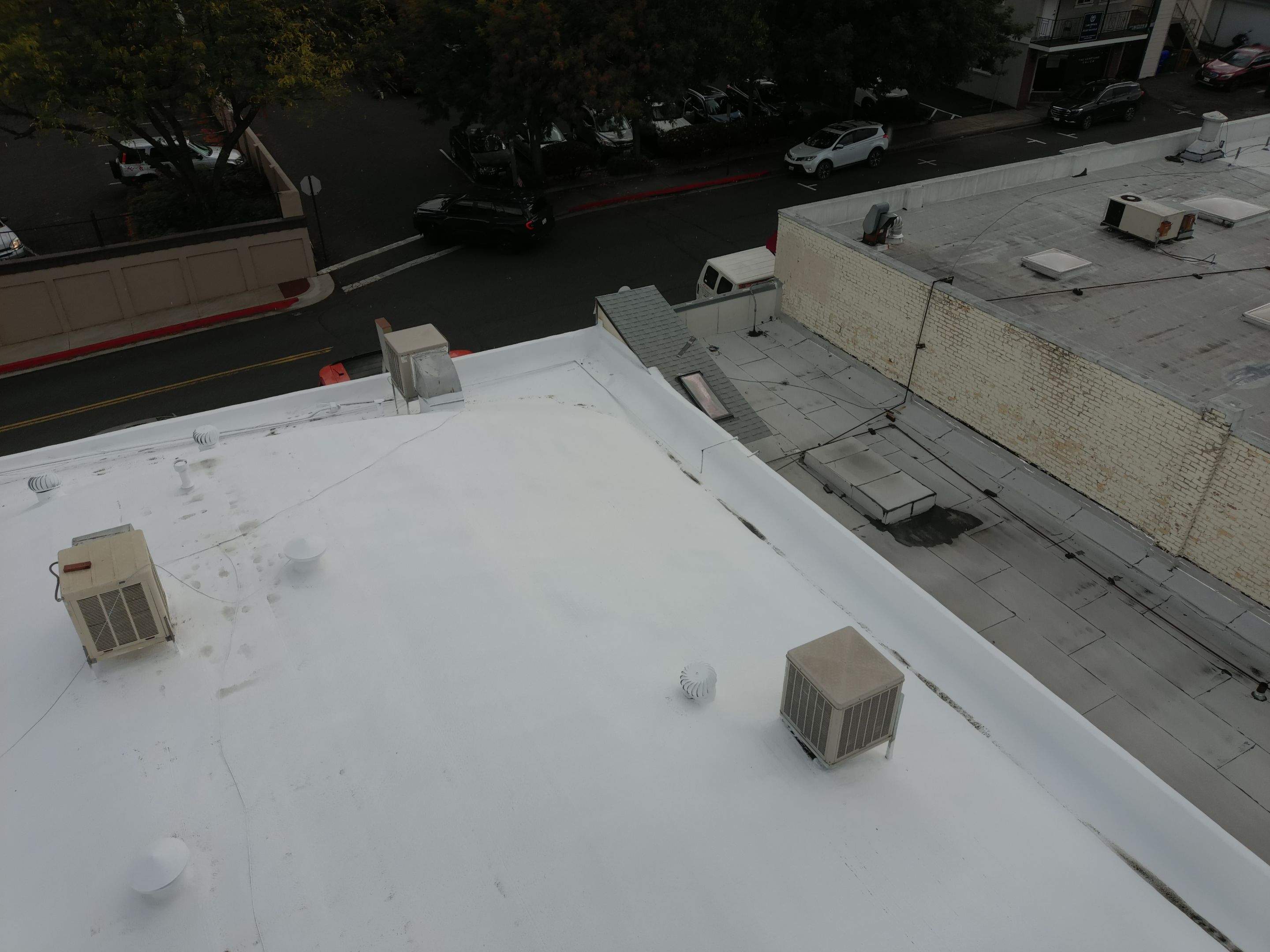 Foam and coatings on commercial roof by Straight Edge Roofing Inc
