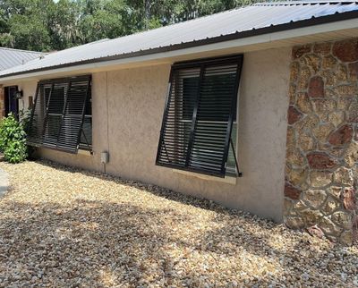 Hurricane Rated Bahama Shutters in Gray Brown