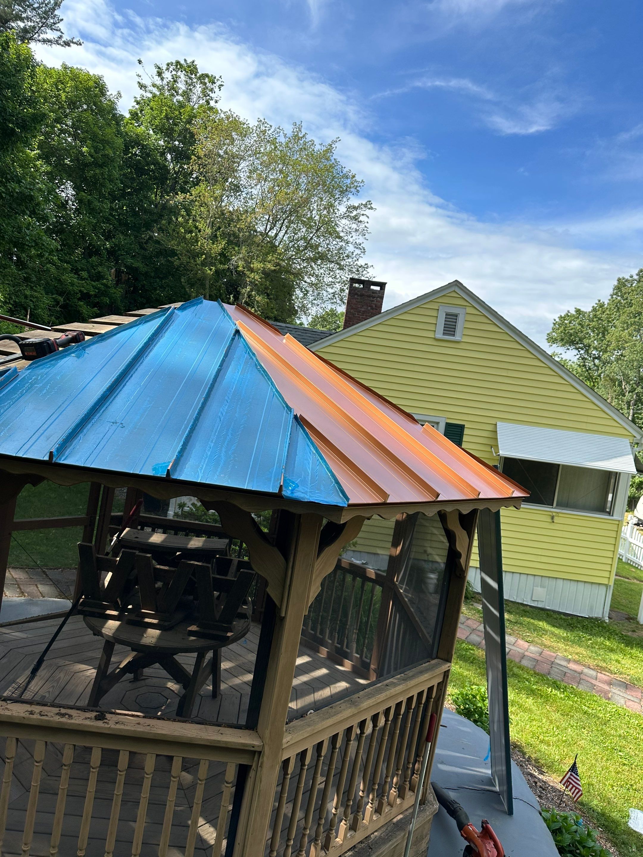 Residential Roofing Installation using Copper Penny Metal Roof by A Plus Exterior