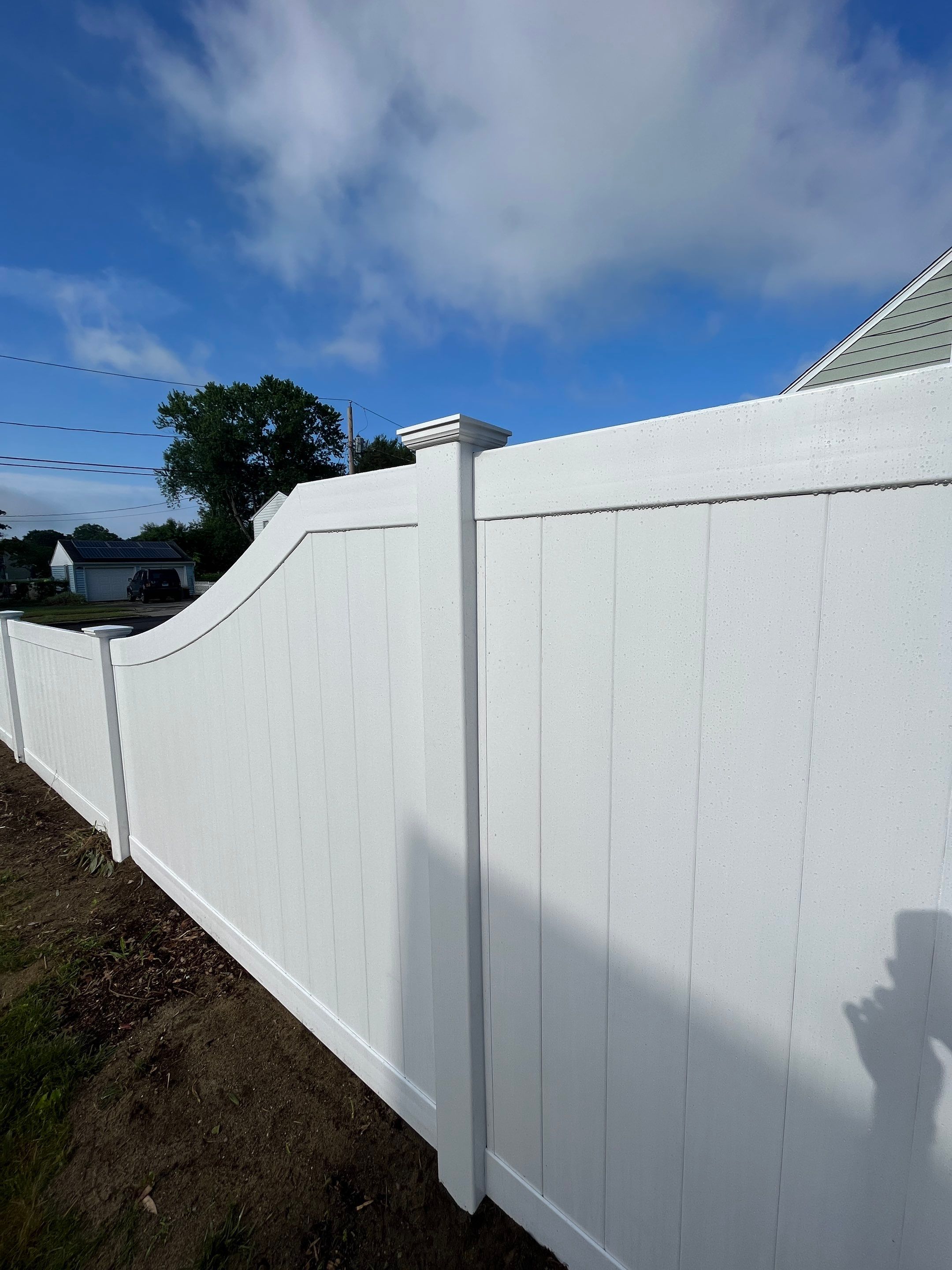 Replacement Vinyl Privacy fence with Transition piece in White by DiGiorgi Roofing and Siding Inc