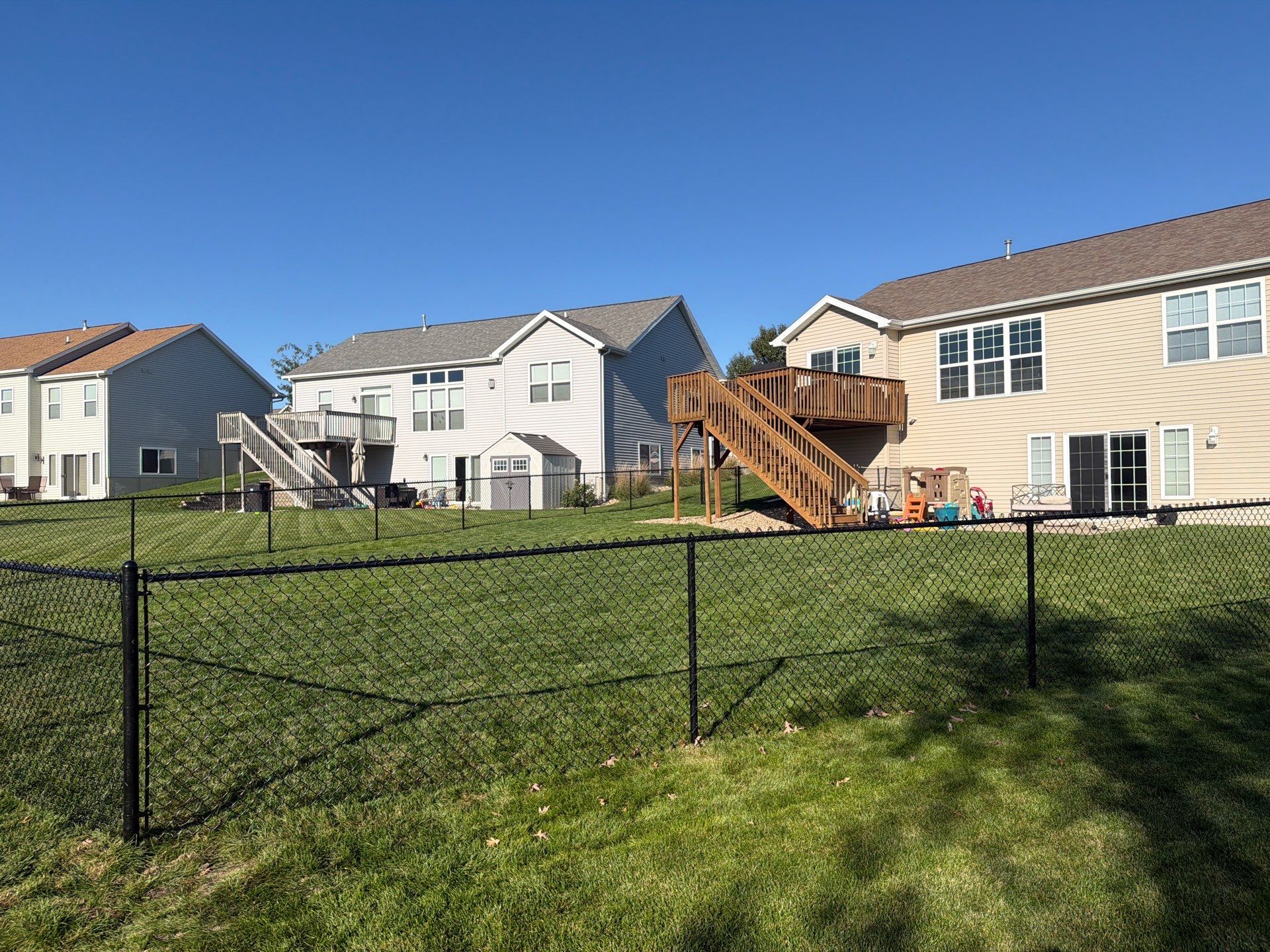 Black Vinyl-Coated Chain Link Fence Installation in Cedar Falls by Perfect Picket Fence and Stain