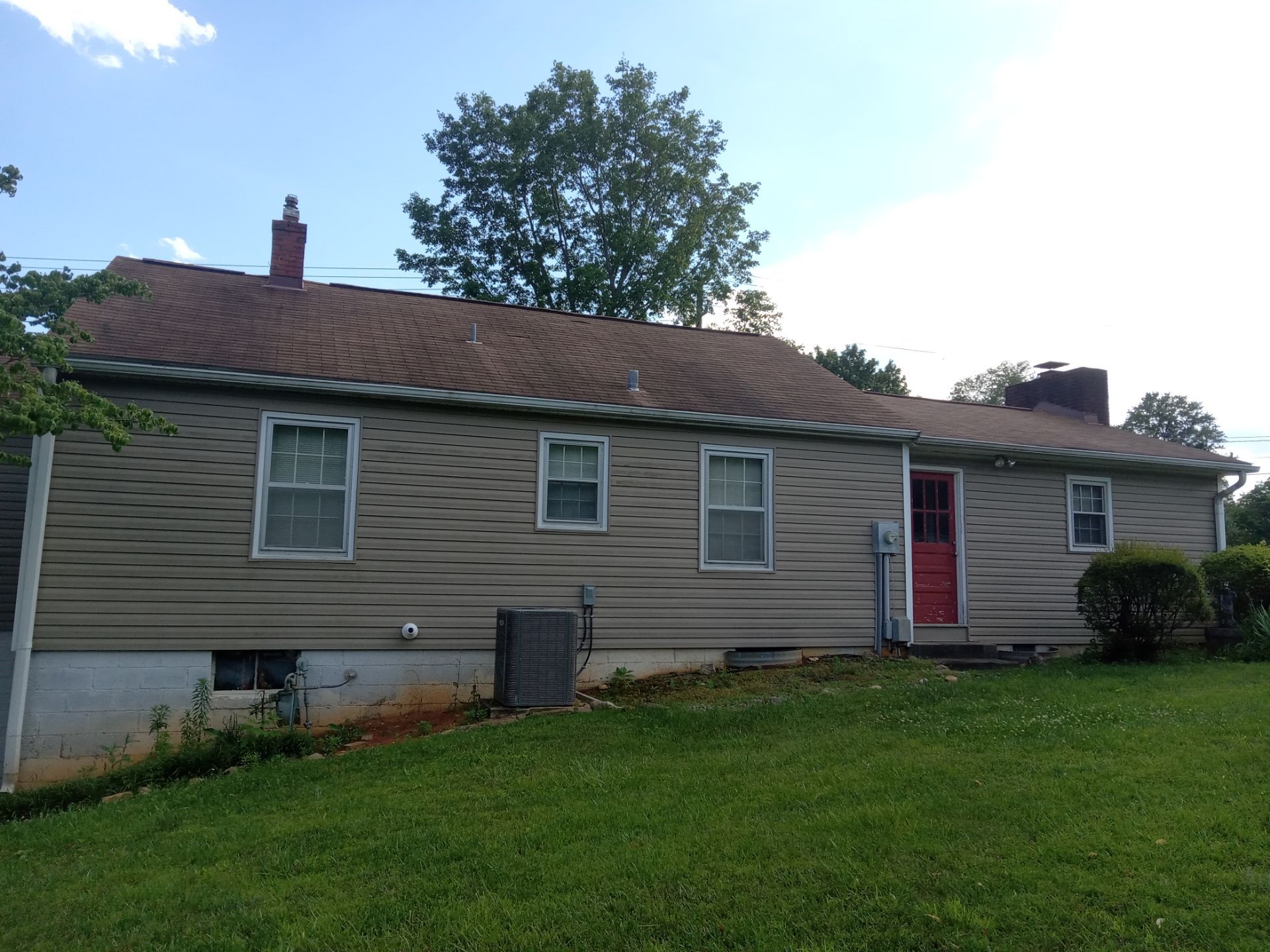 the pressure washing service being provided for the house in the photo is focusing on cleaning the exterior siding of the house removing dirt mildew and any other buildup that can accumulate on the surface over time the cleaning enhances the overall appearance of the property and helps to maintain the material of the siding by preventing decay and wear caused by the elements