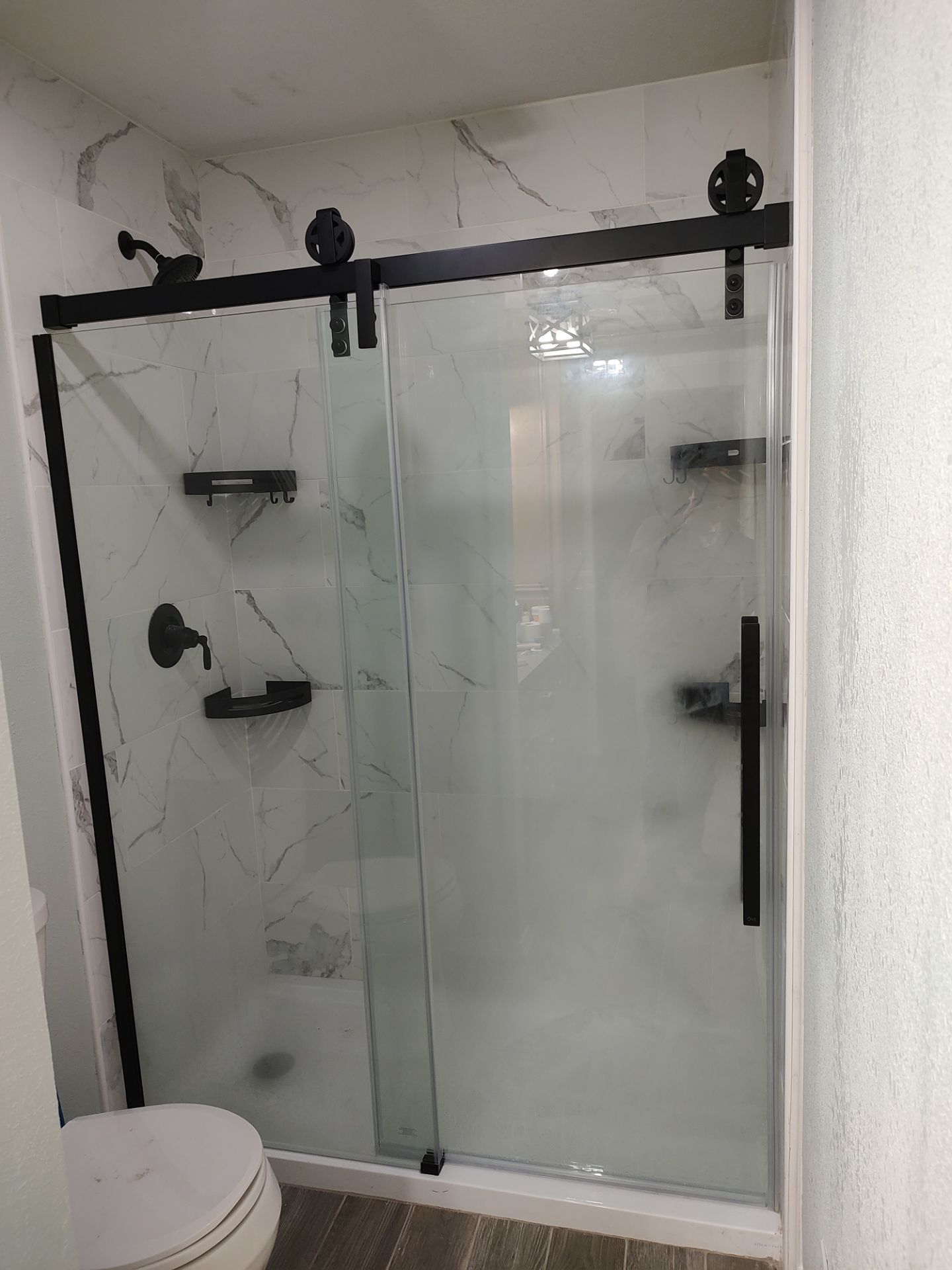 Bathroom remodel w/shower upgrade by In & Out Construction & Remodeling, LLC