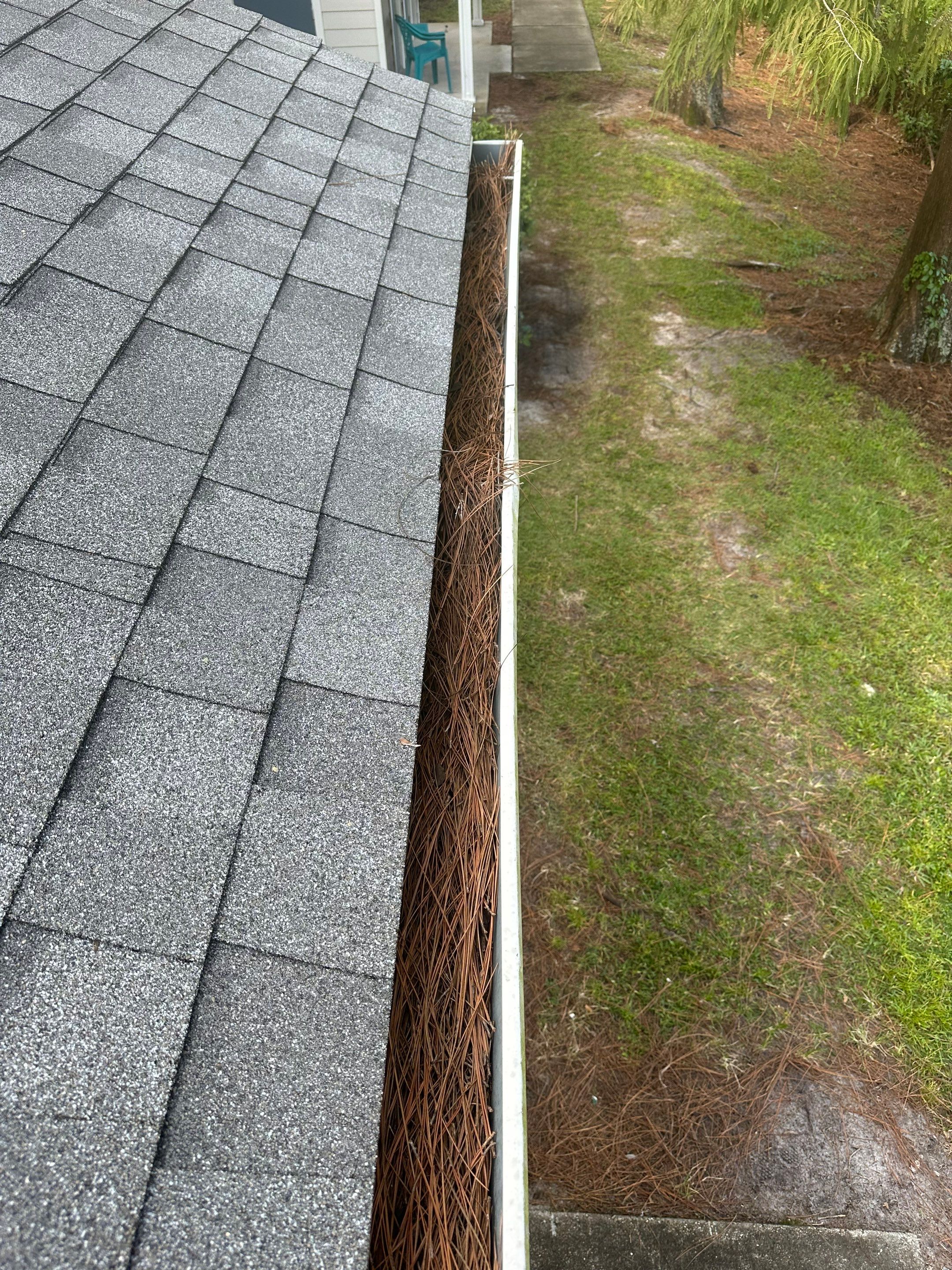 Commercial gutter cleaning Deltona & DeLand before photo with filled gutters