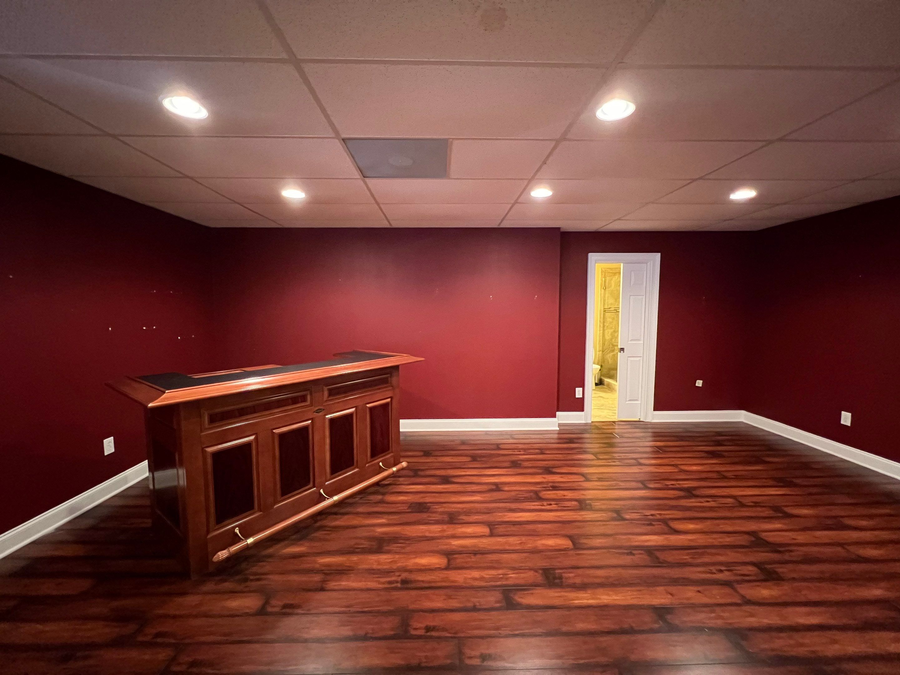 Modern Basement Remodeling in Woodstock with Custom Live-Edge Bar by Swift Home Renovations