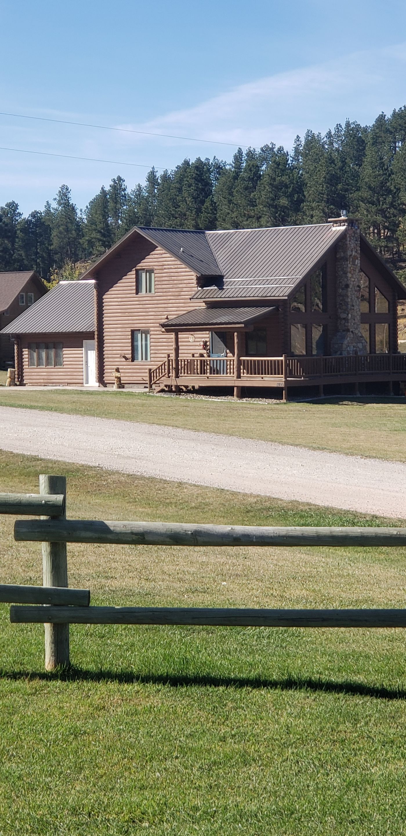 Hill Country Guest Ranch using Steel Roofing, Gutters, Log Cabin Staining by Lightning Exteriors