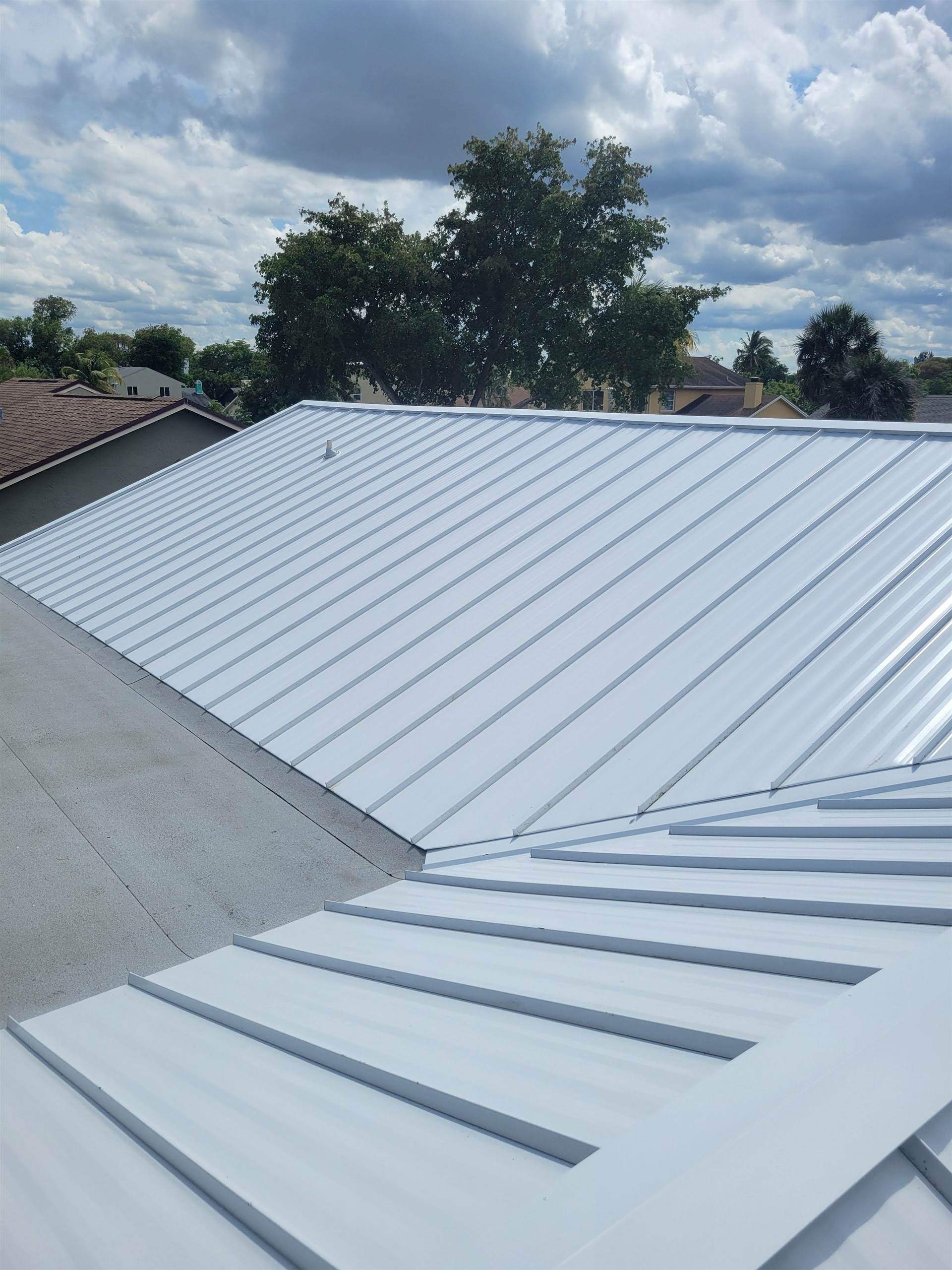 Standing Seam Metal & Flat Re-Roof using 1.5" Nail Strip 24ga Solar White Kynar Coated Standing Seam Metal Panels by Morton Roofing, Inc.