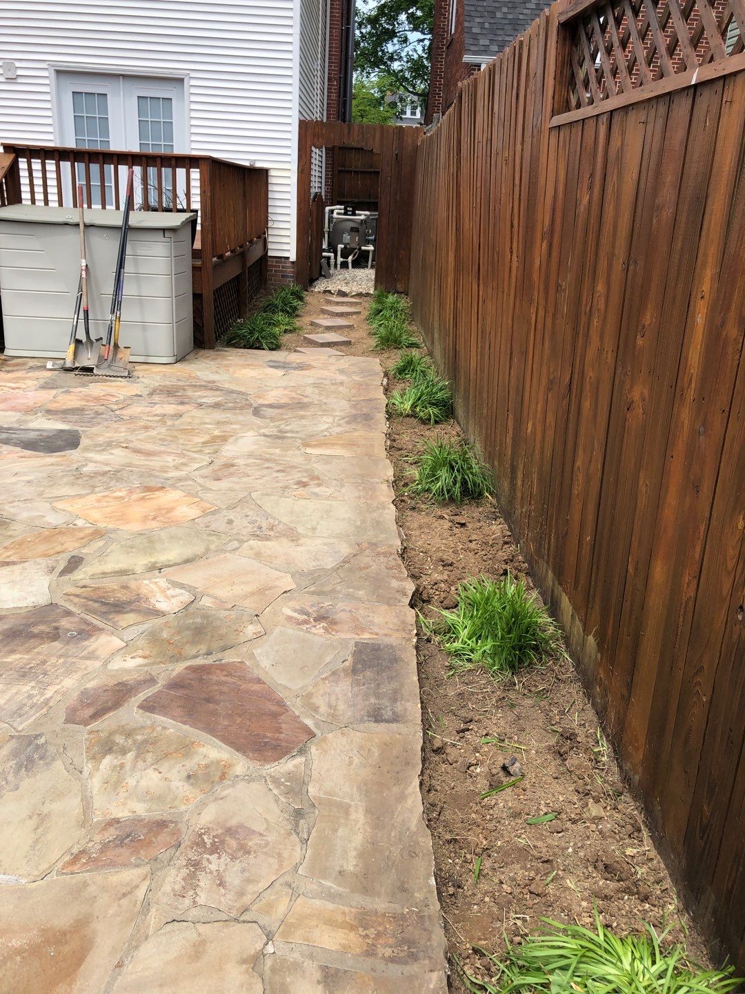 Liriope grasses, mulch and stone pavers by GrassBusters, Inc.