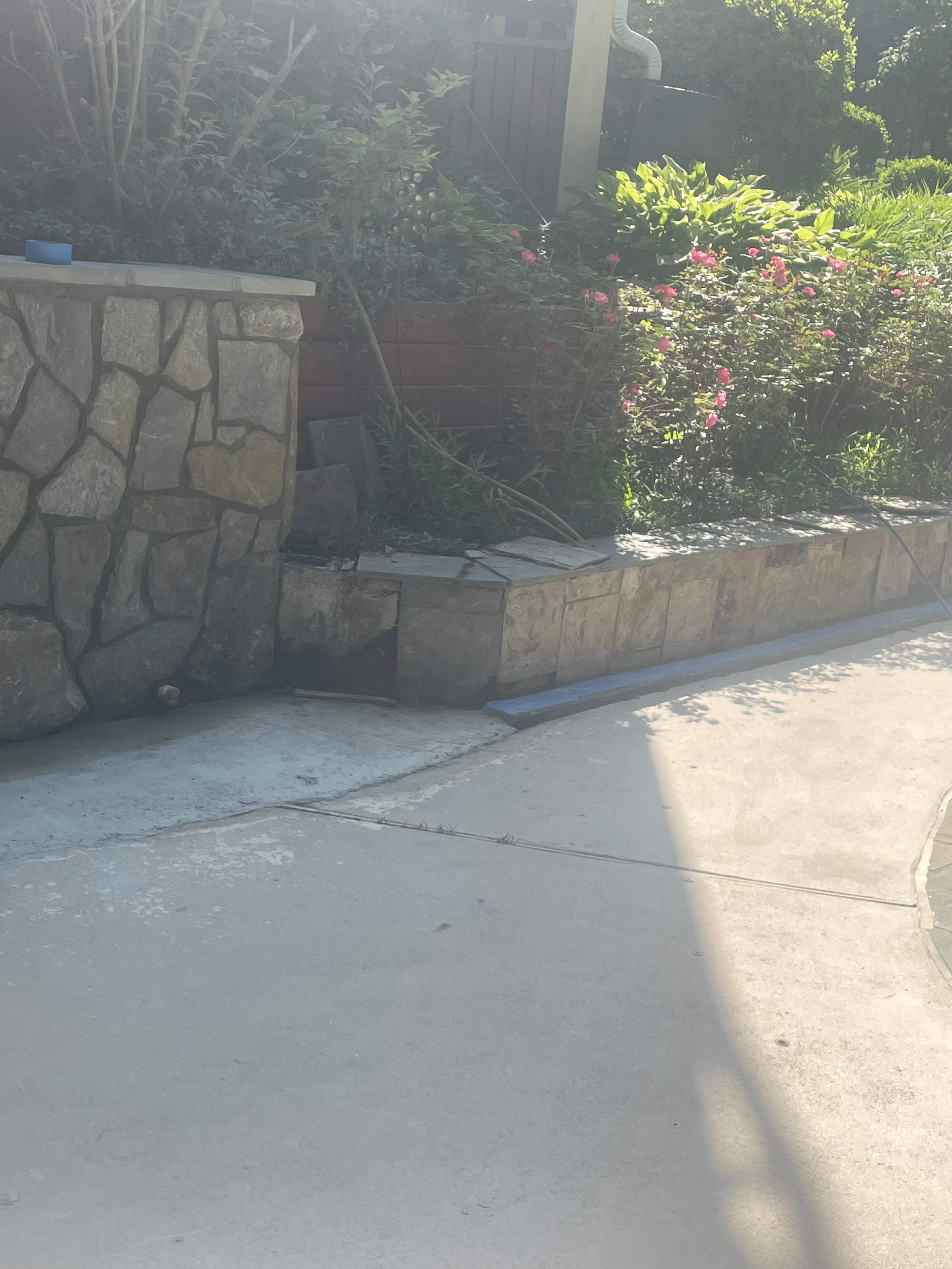 Pool Surround remodel with retaining walls, new waterfall and water slide by Fairfax Contractors, LLC