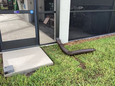 Musket brown seamless gutters with splash guards, new downspouts, and extensions in Bradenton, FL