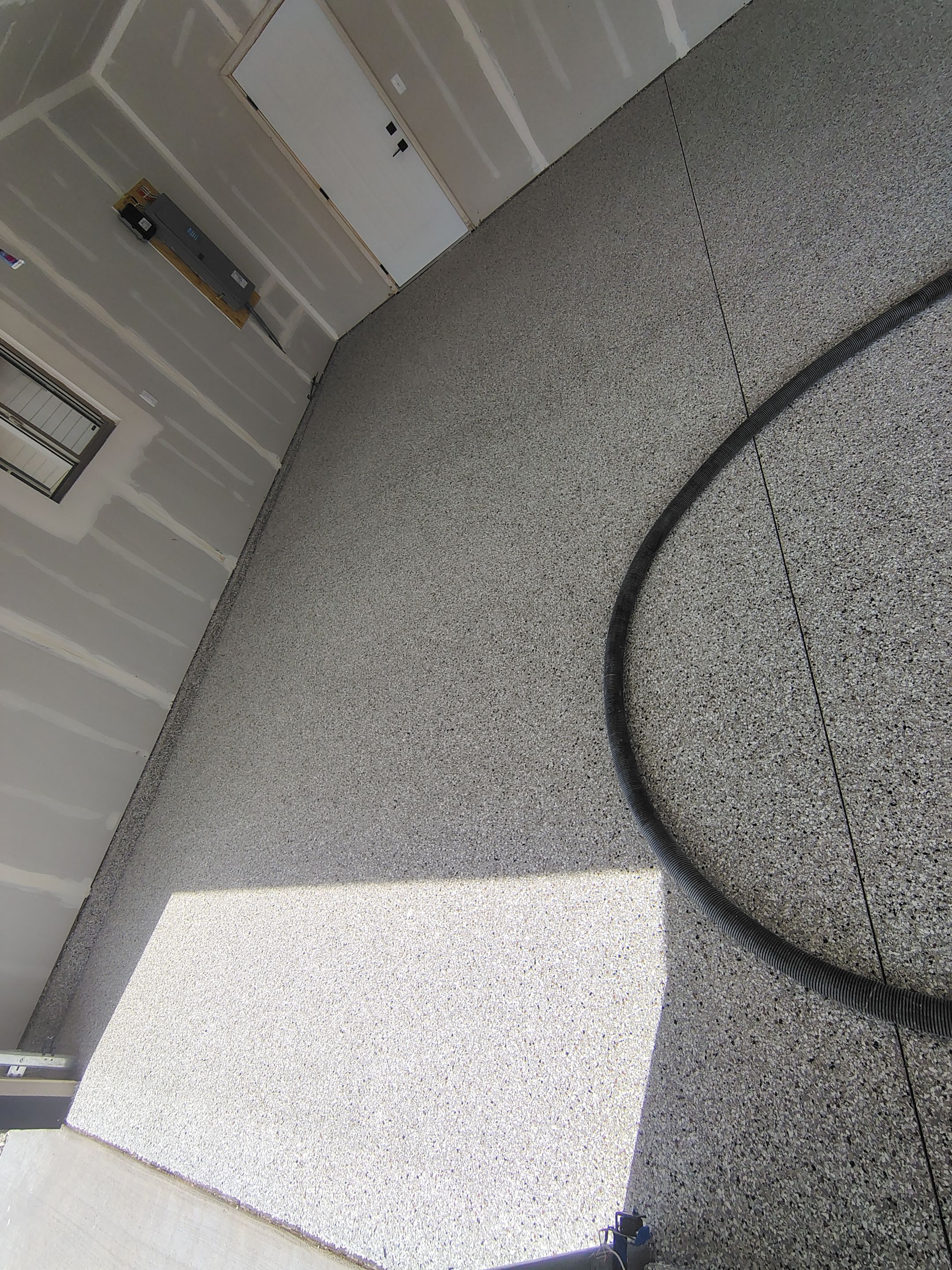 Speckled Epoxy Garage Floor Coating Installation in Sioux Falls by Select Painting, Coatings & Garage Cabinets