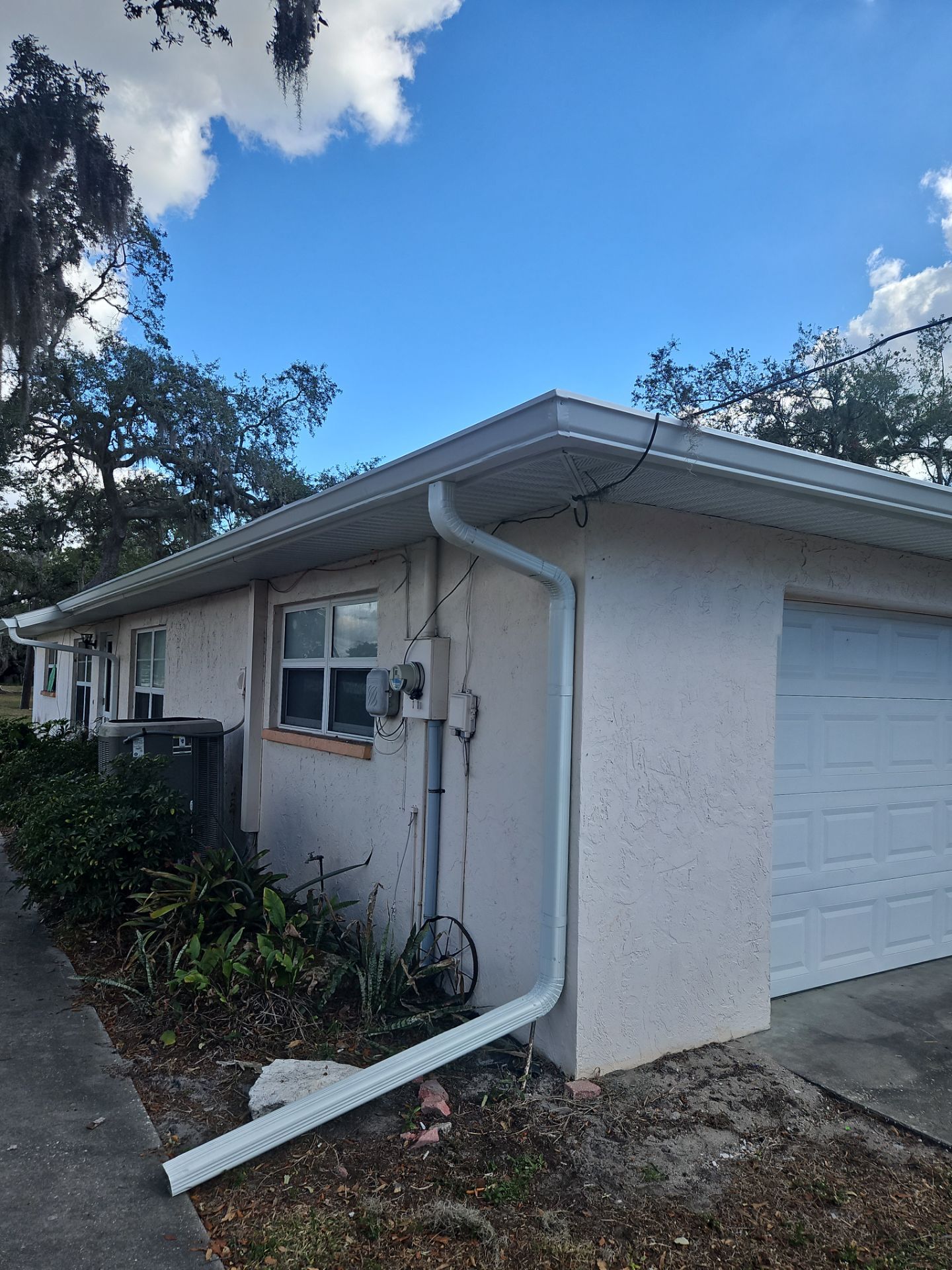 Downspout Installation using White Down Spouts in Sarasota FL by Gutter Professors