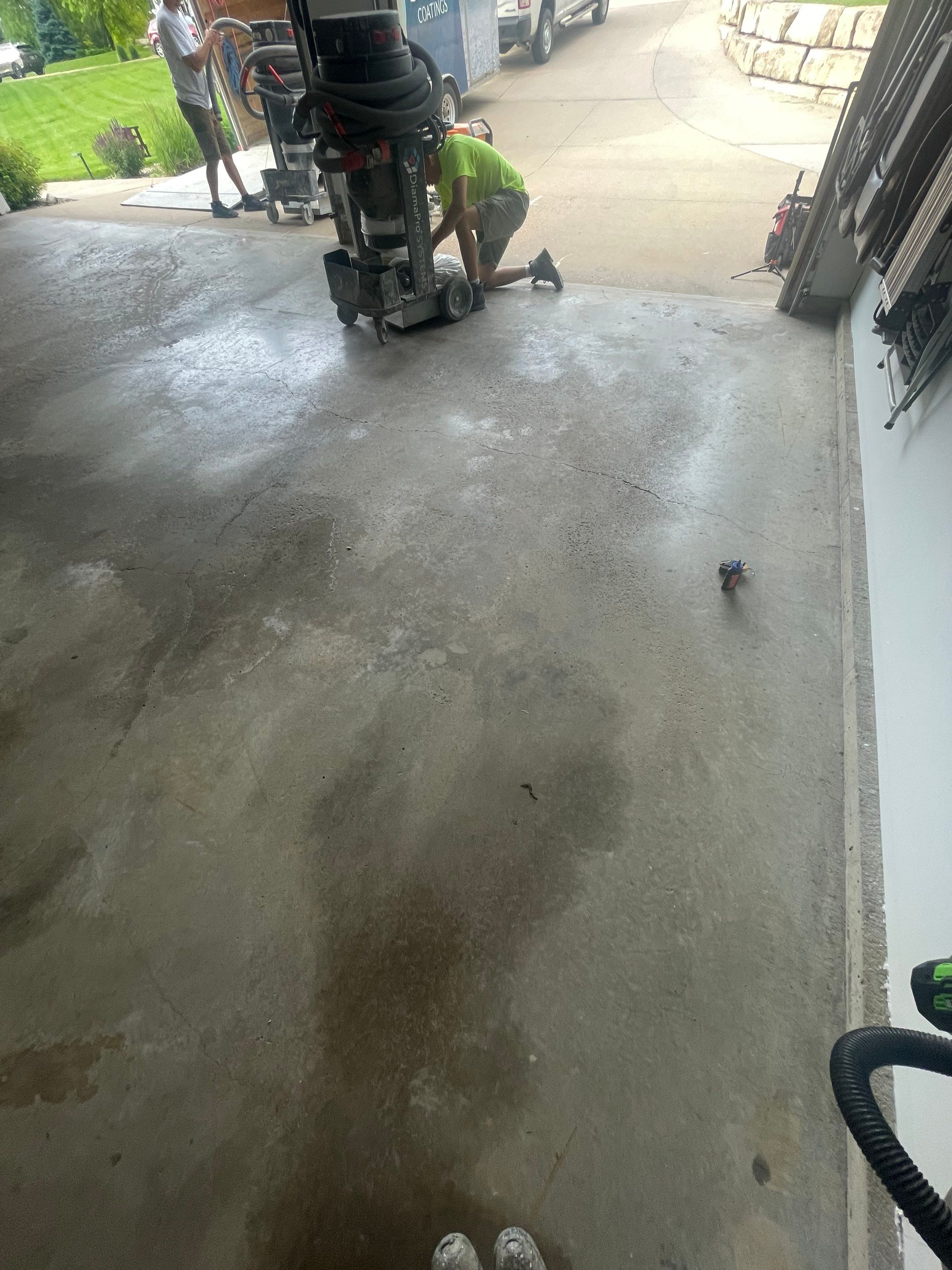 Feather Grey Garage Floor Coating Installation in Sioux Falls by Select Painting, Coatings & Garage Cabinets