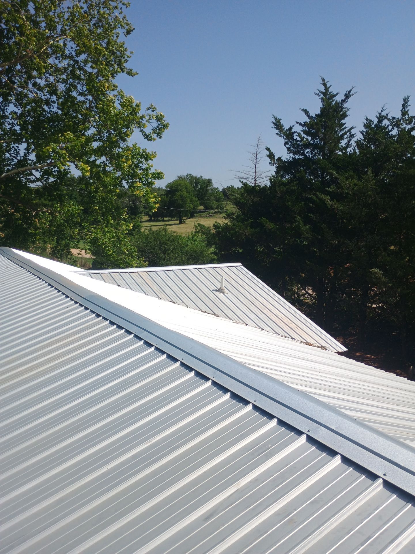 Corrugated Metal Roof Repair for Brick Home in Lindsay by BANA Roofing and Solar Supply